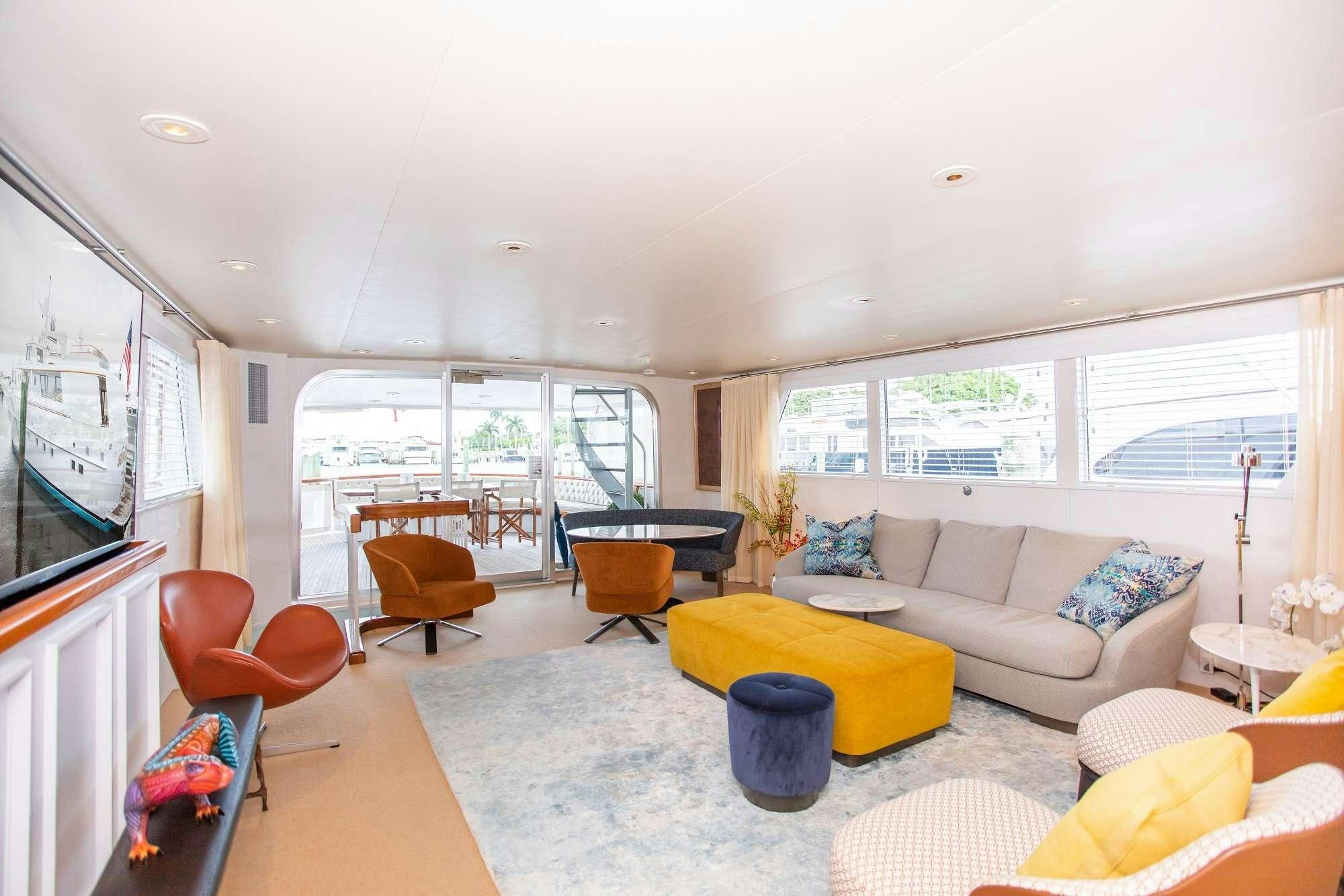 a living room with a couch and a table aboard SOVEREIGN Yacht for Charter