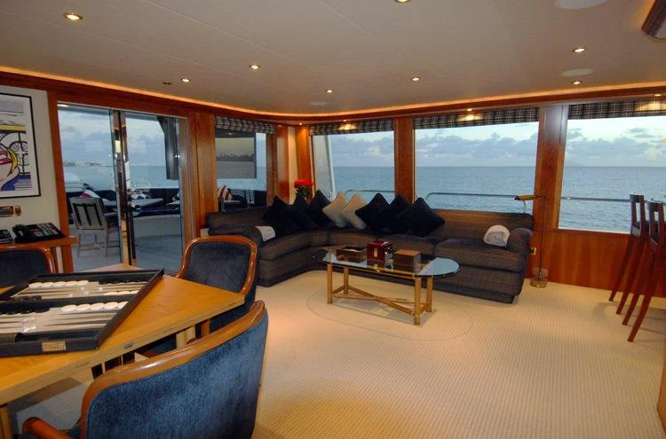a living room with a large window aboard DONA LOLA Yacht for Charter