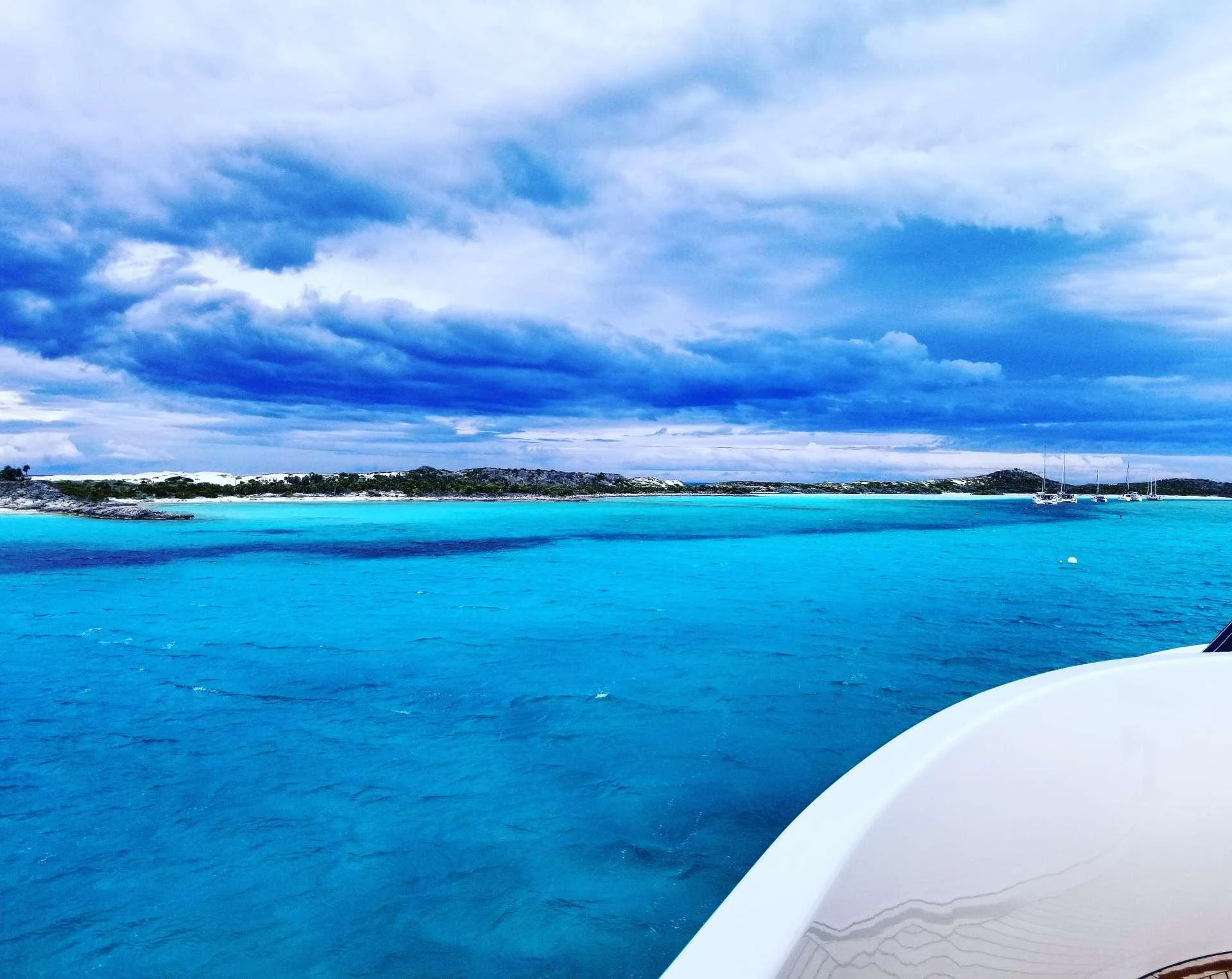 a body of water with a land in the distance aboard DONA LOLA Yacht for Charter