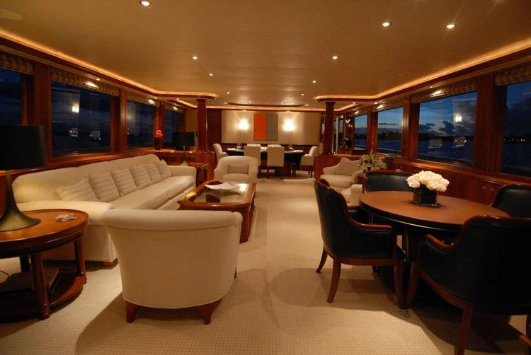 a living room with a couch and a table aboard DONA LOLA Yacht for Charter