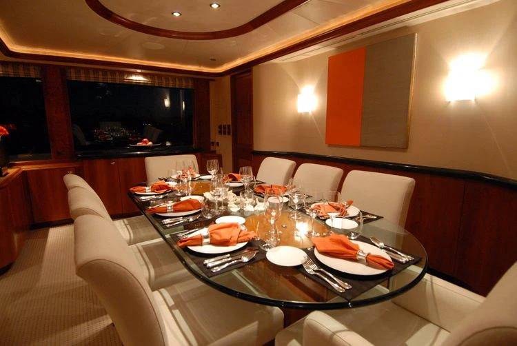 a table with plates and glasses on it aboard DONA LOLA Yacht for Charter