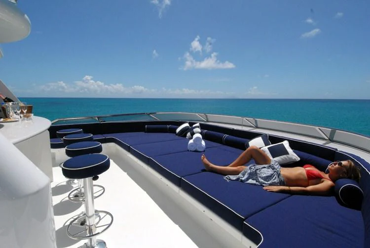 a woman lying on a boat aboard DONA LOLA Yacht for Charter