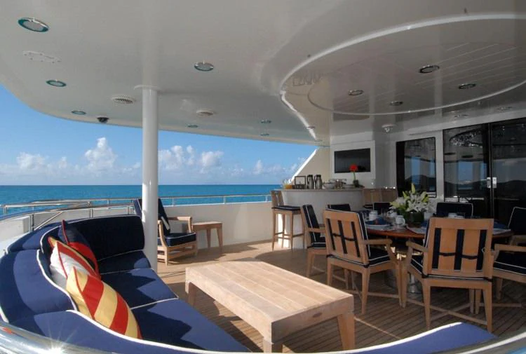 a room with a table chairs and a view of the ocean aboard DONA LOLA Yacht for Charter