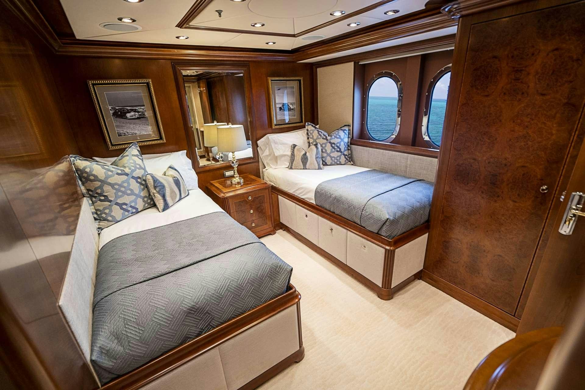 a room with a bed and a couch aboard CAMILLE Yacht for Charter