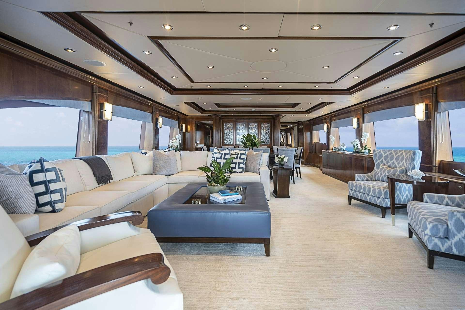 a living room with a large window aboard CAMILLE Yacht for Charter