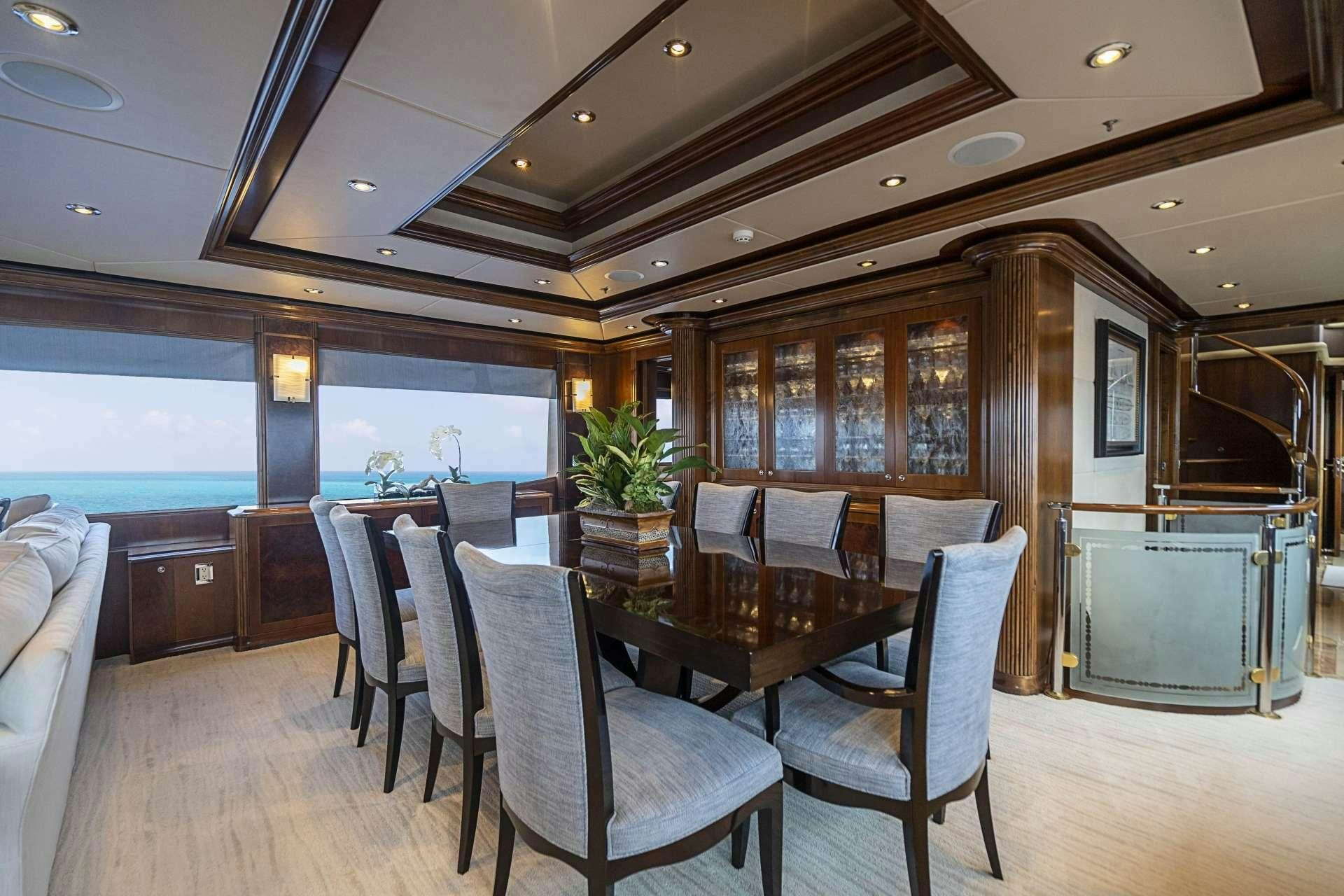 a room with a table chairs and a large window aboard CAMILLE Yacht for Charter