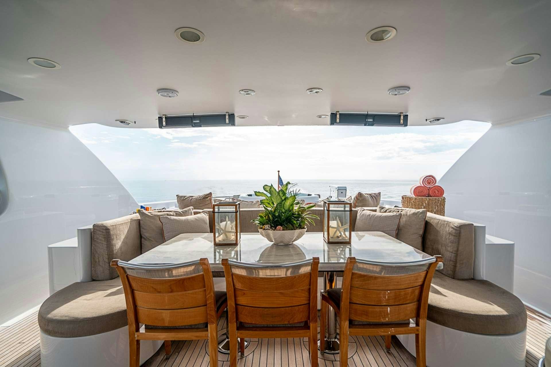 a room with a table and chairs aboard CAMILLE Yacht for Charter