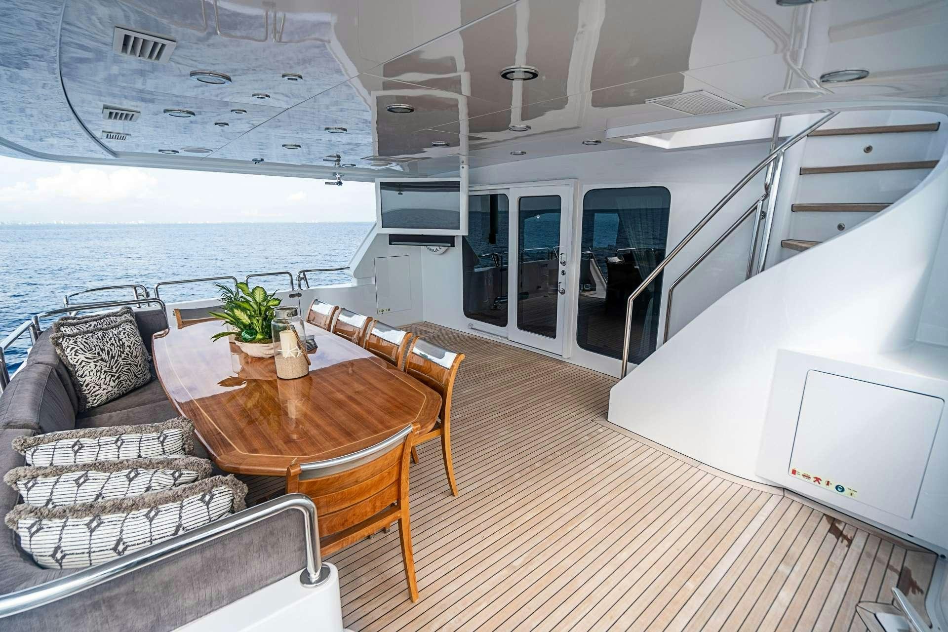 a boat with a table and chairs aboard CAMILLE Yacht for Charter