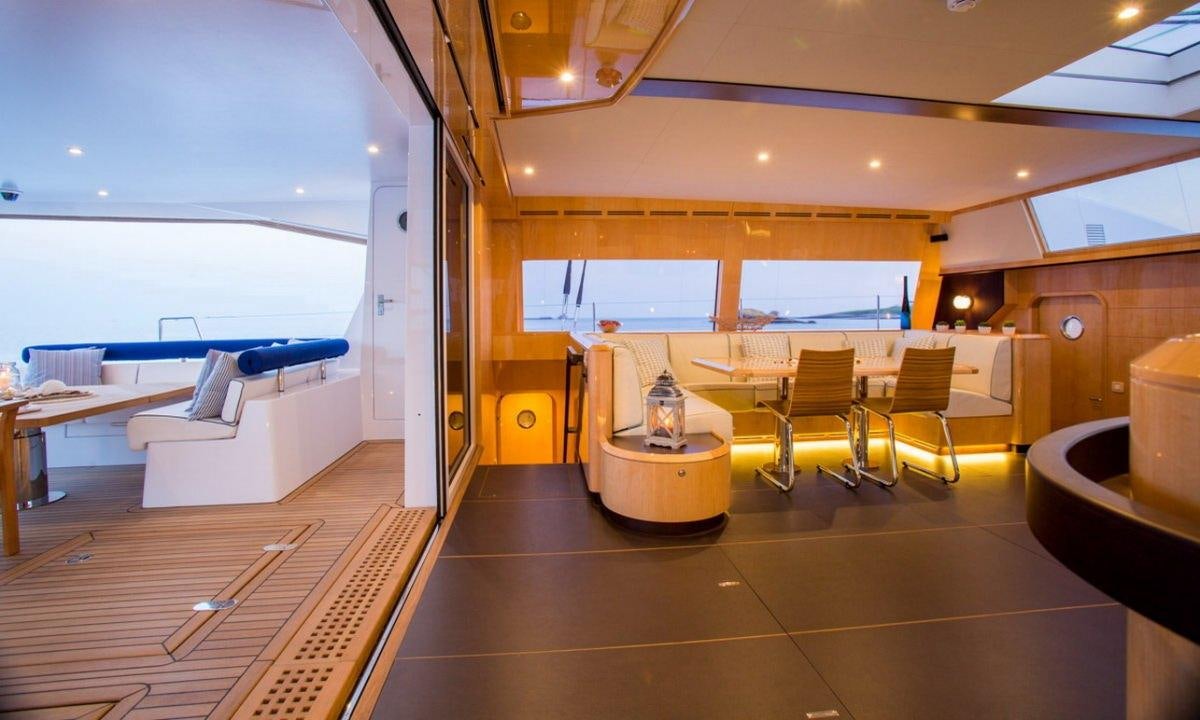 a room with a table and chairs aboard WINDQUEST Yacht for Charter