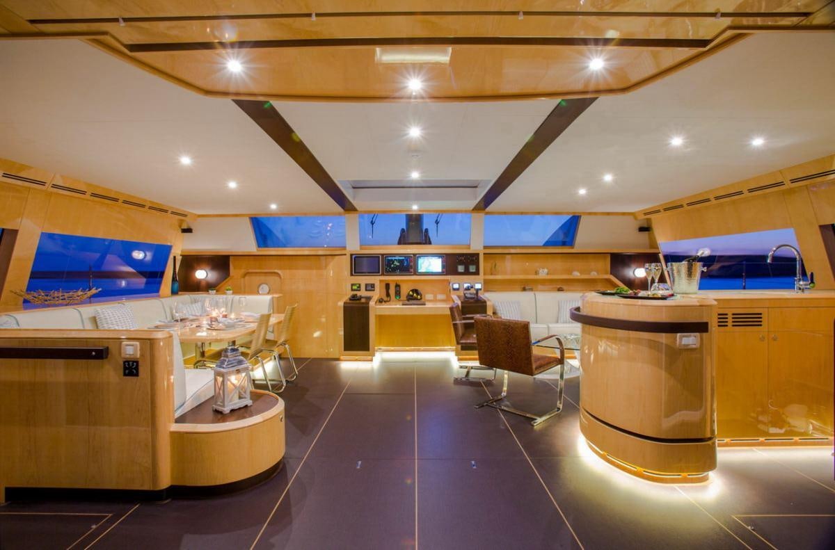 a large kitchen with a bar and seating area aboard WINDQUEST Yacht for Charter
