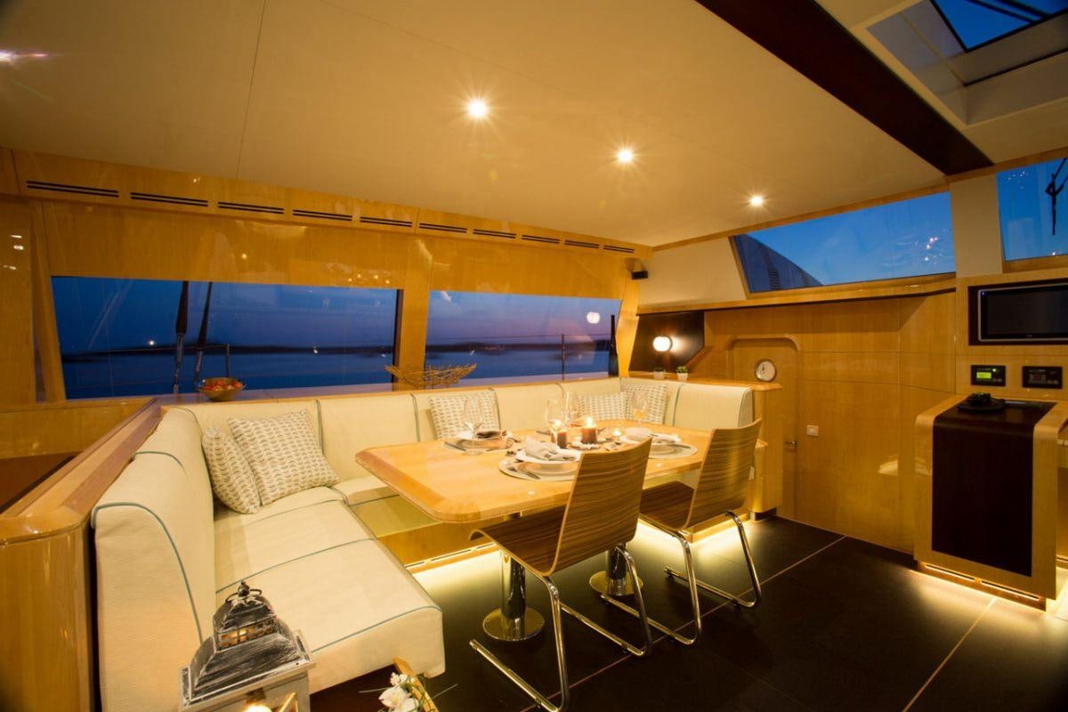 a room with a table and chairs aboard WINDQUEST Yacht for Charter