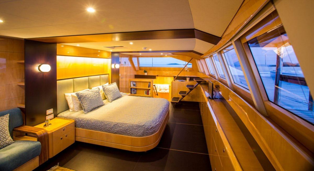a room with a bed and a window aboard WINDQUEST Yacht for Charter