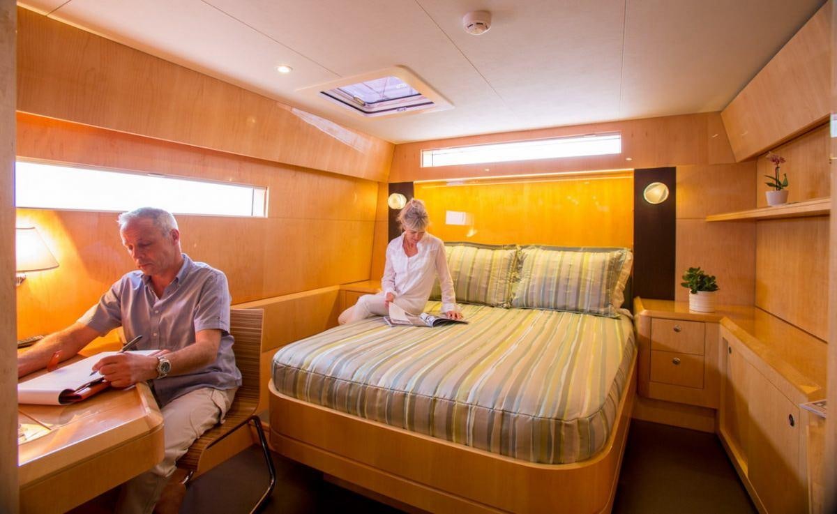 a man and a woman sitting in a room aboard WINDQUEST Yacht for Charter