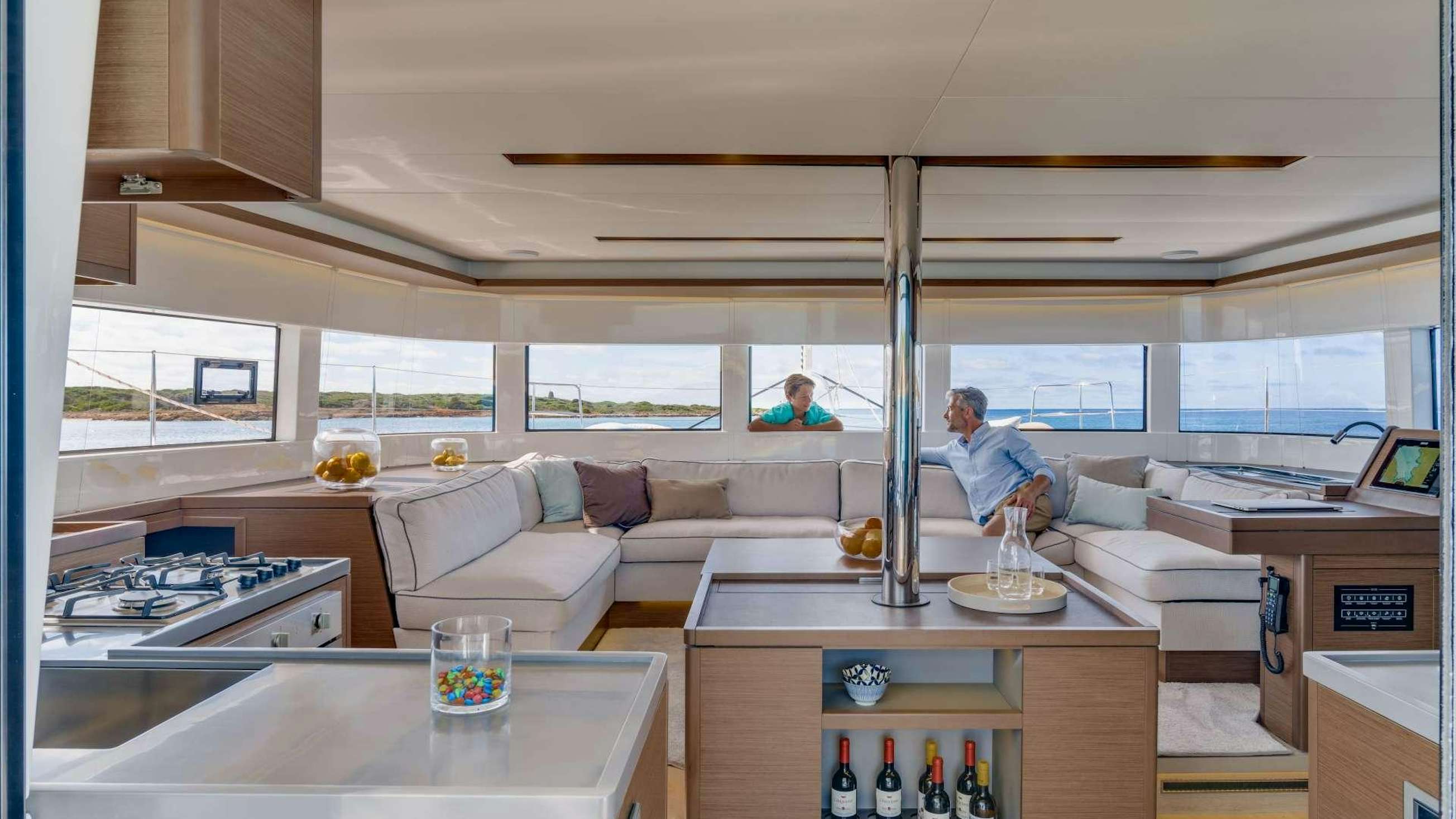 a room with a couch and a table with bottles on it aboard ESPERANZA II Yacht for Charter