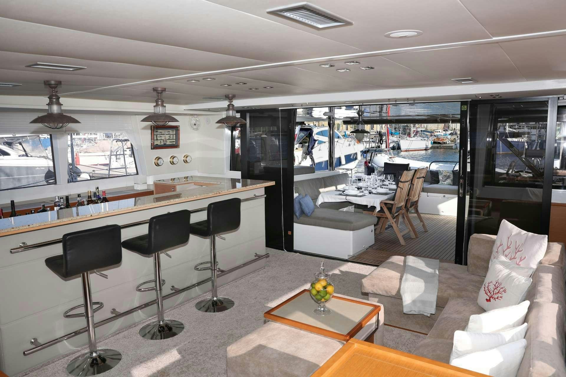 a room with a couch and chairs aboard Spirit of Adventure Lagoon 620  Yacht for Charter