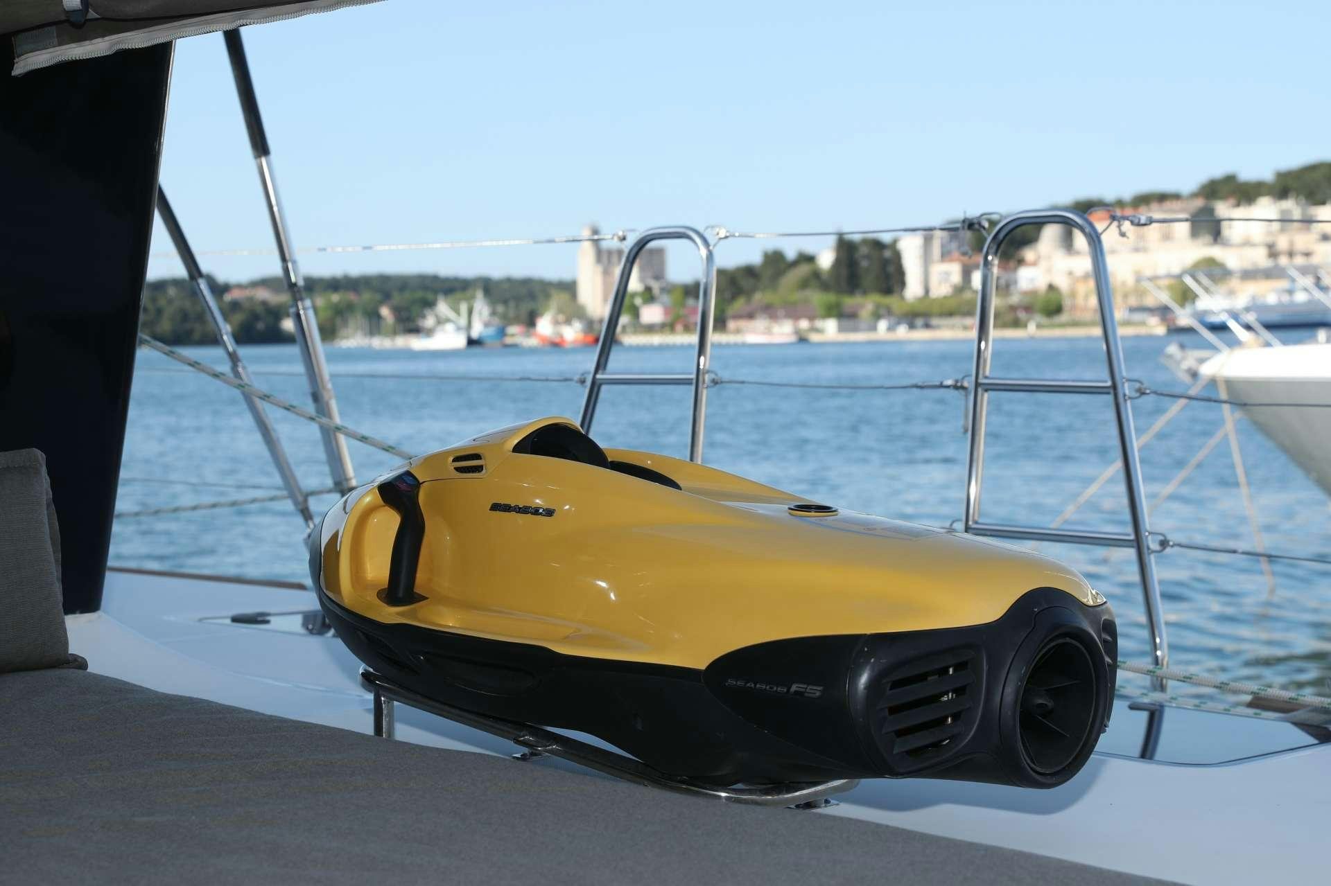 a yellow gondola on a dock aboard Spirit of Adventure Lagoon 620  Yacht for Charter