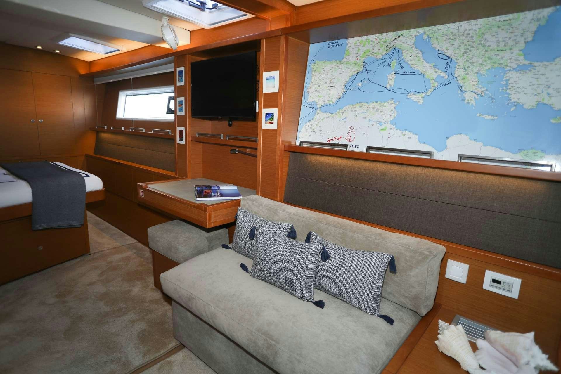 a room with a couch and a tv aboard Spirit of Adventure Lagoon 620  Yacht for Charter