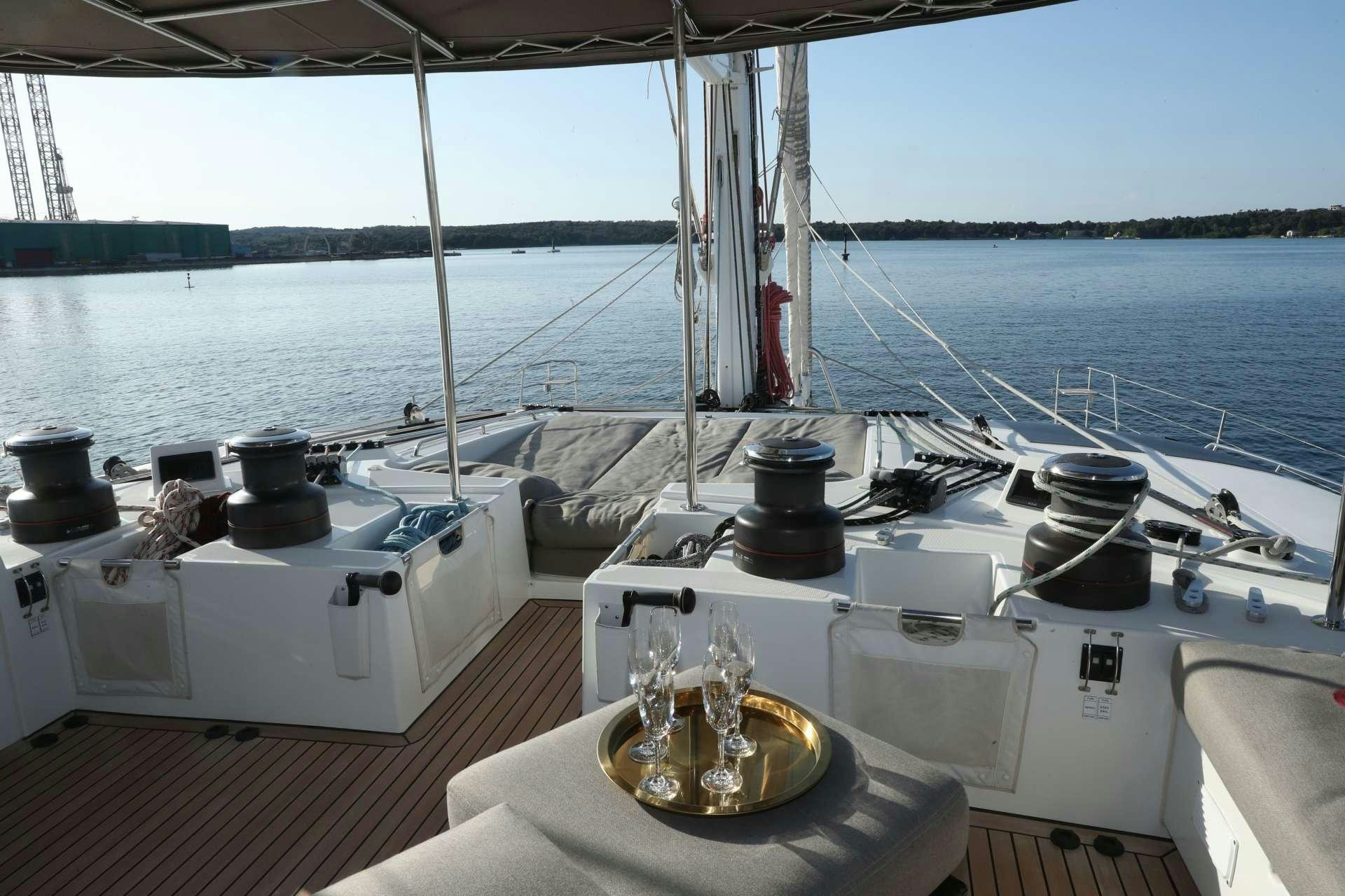 a boat with a table and a bottle on it aboard Spirit of Adventure Lagoon 620  Yacht for Charter
