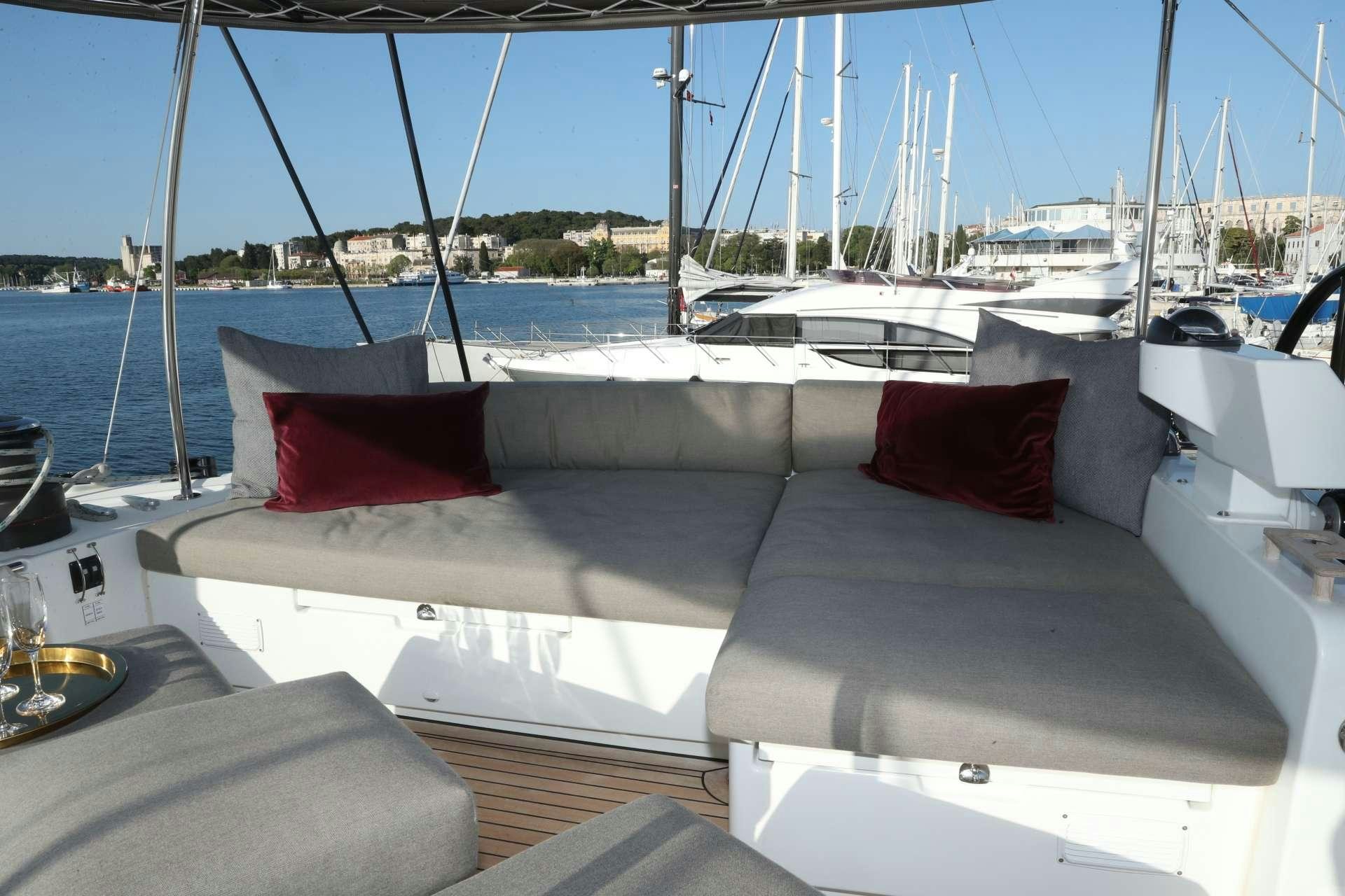 a boat with red pillows aboard Spirit of Adventure Lagoon 620  Yacht for Charter