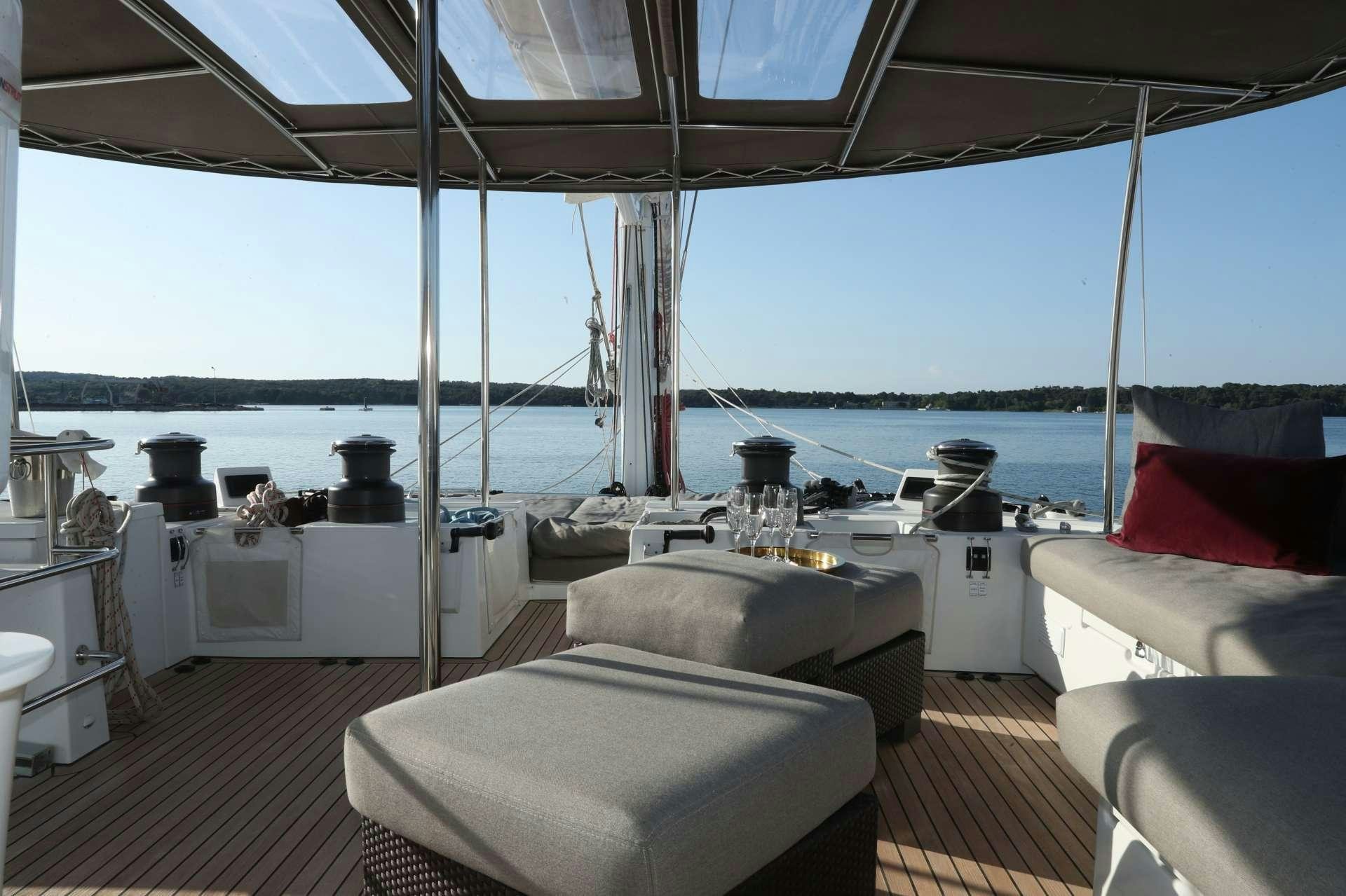 a boat with a large deck aboard Spirit of Adventure Lagoon 620  Yacht for Charter