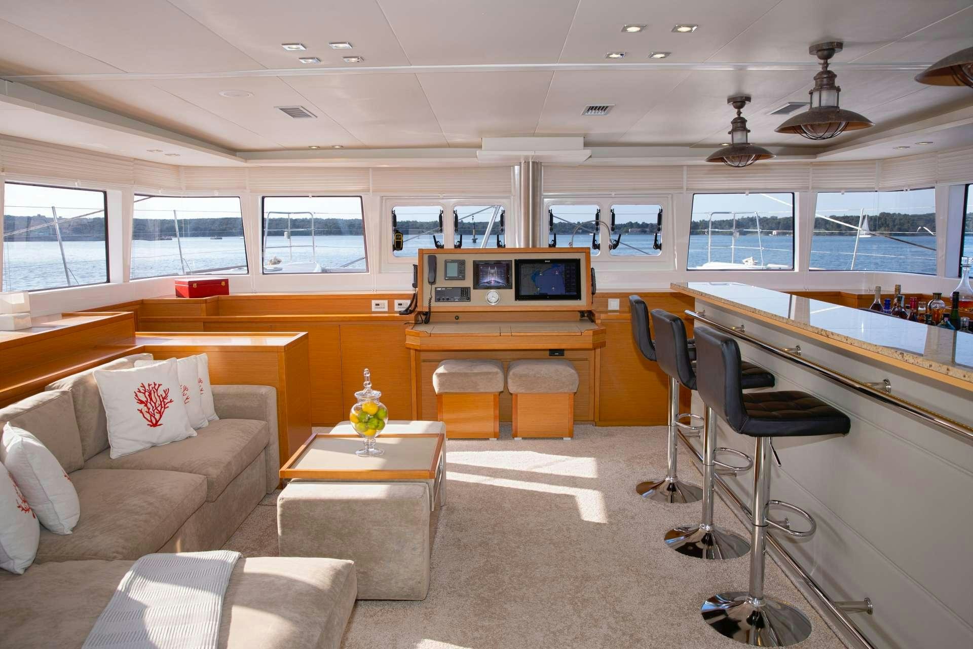 a room with a couch and a table and chairs aboard Spirit of Adventure Lagoon 620  Yacht for Charter