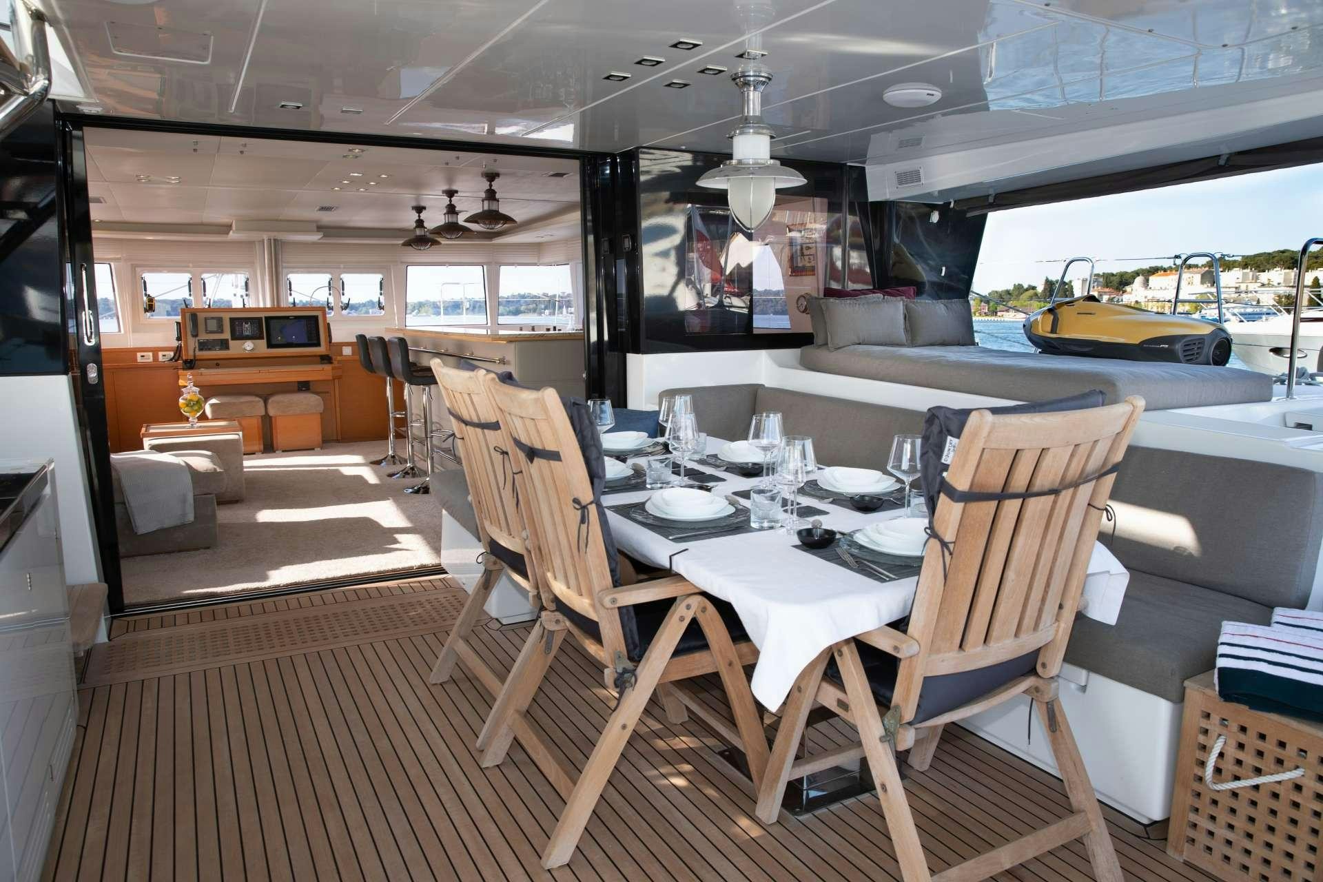 a dining room with a table and chairs aboard Spirit of Adventure Lagoon 620  Yacht for Charter