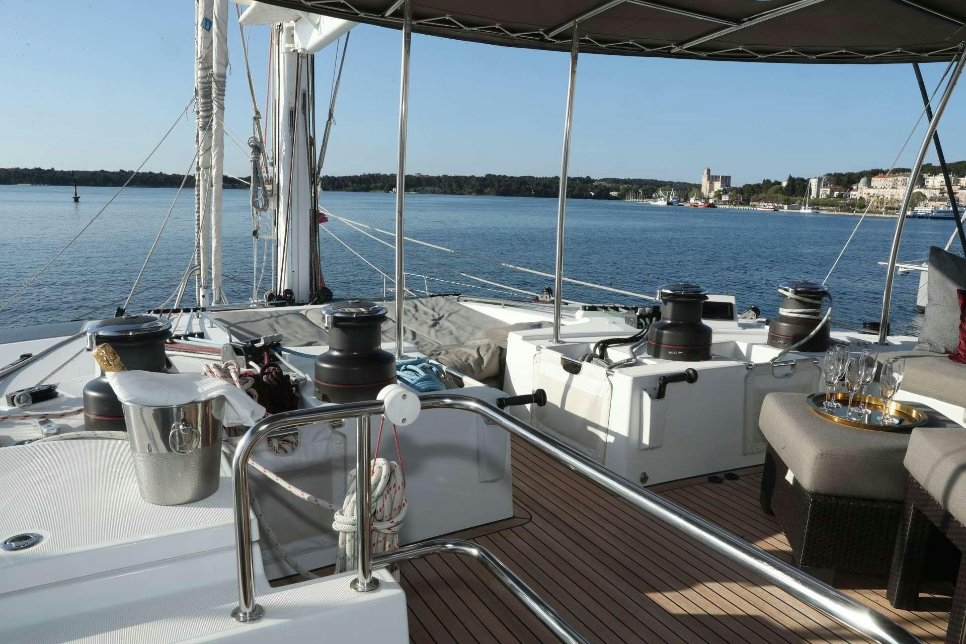 a boat with a table and chairs on it aboard Spirit of Adventure Lagoon 620  Yacht for Charter
