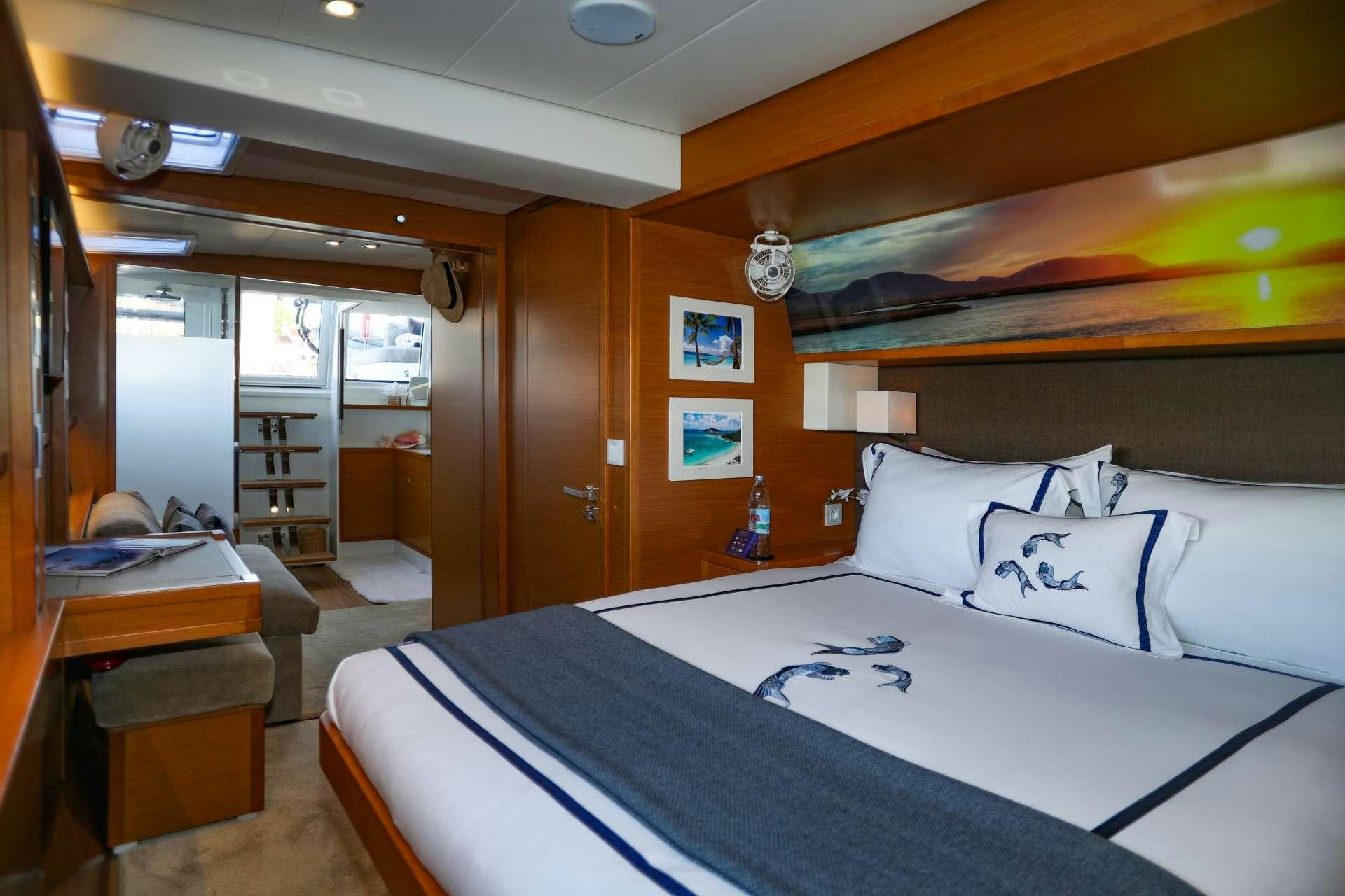 a bedroom with a bed and a desk aboard Spirit of Adventure Lagoon 620  Yacht for Charter