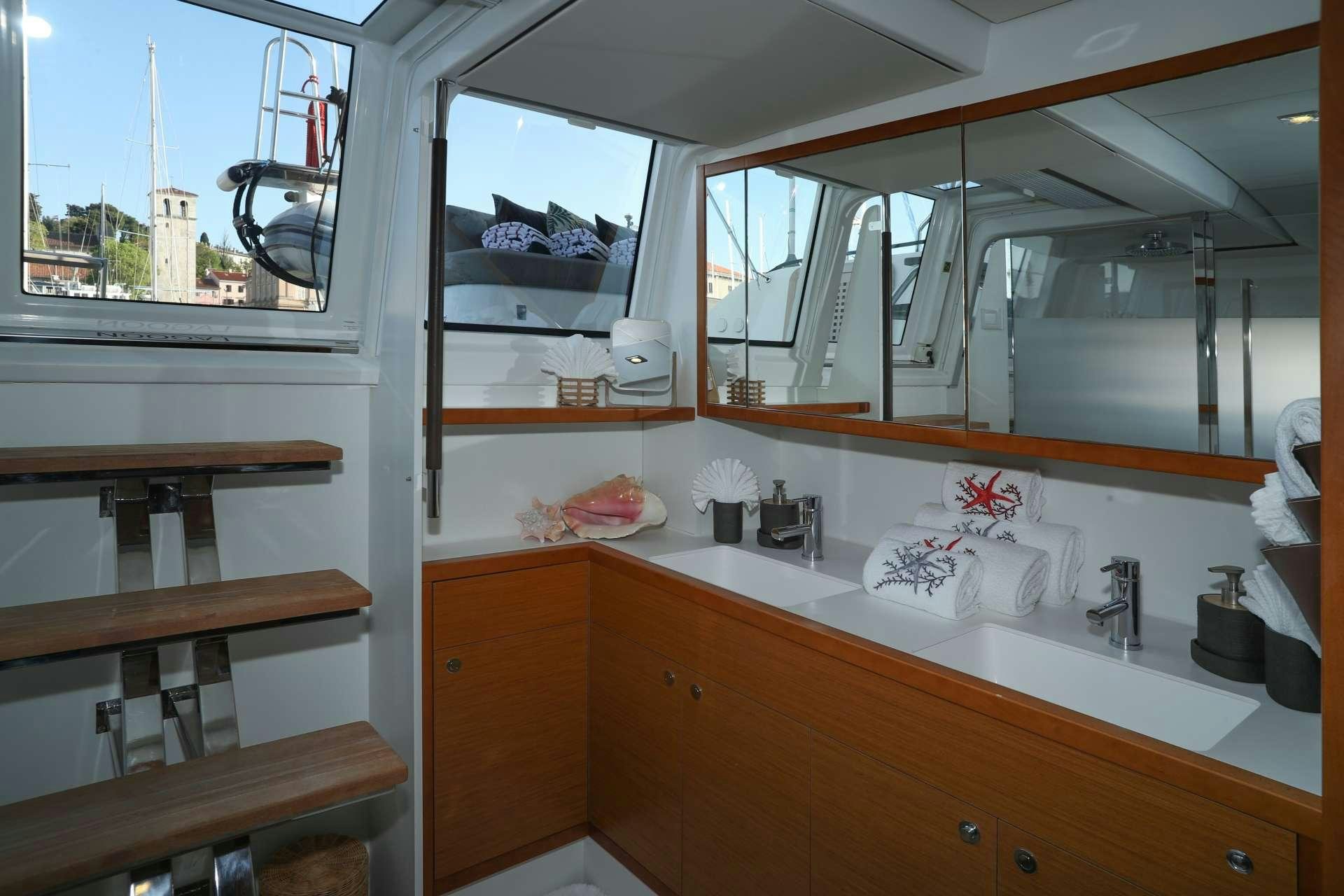 a kitchen with a sink and a window aboard Spirit of Adventure Lagoon 620  Yacht for Charter