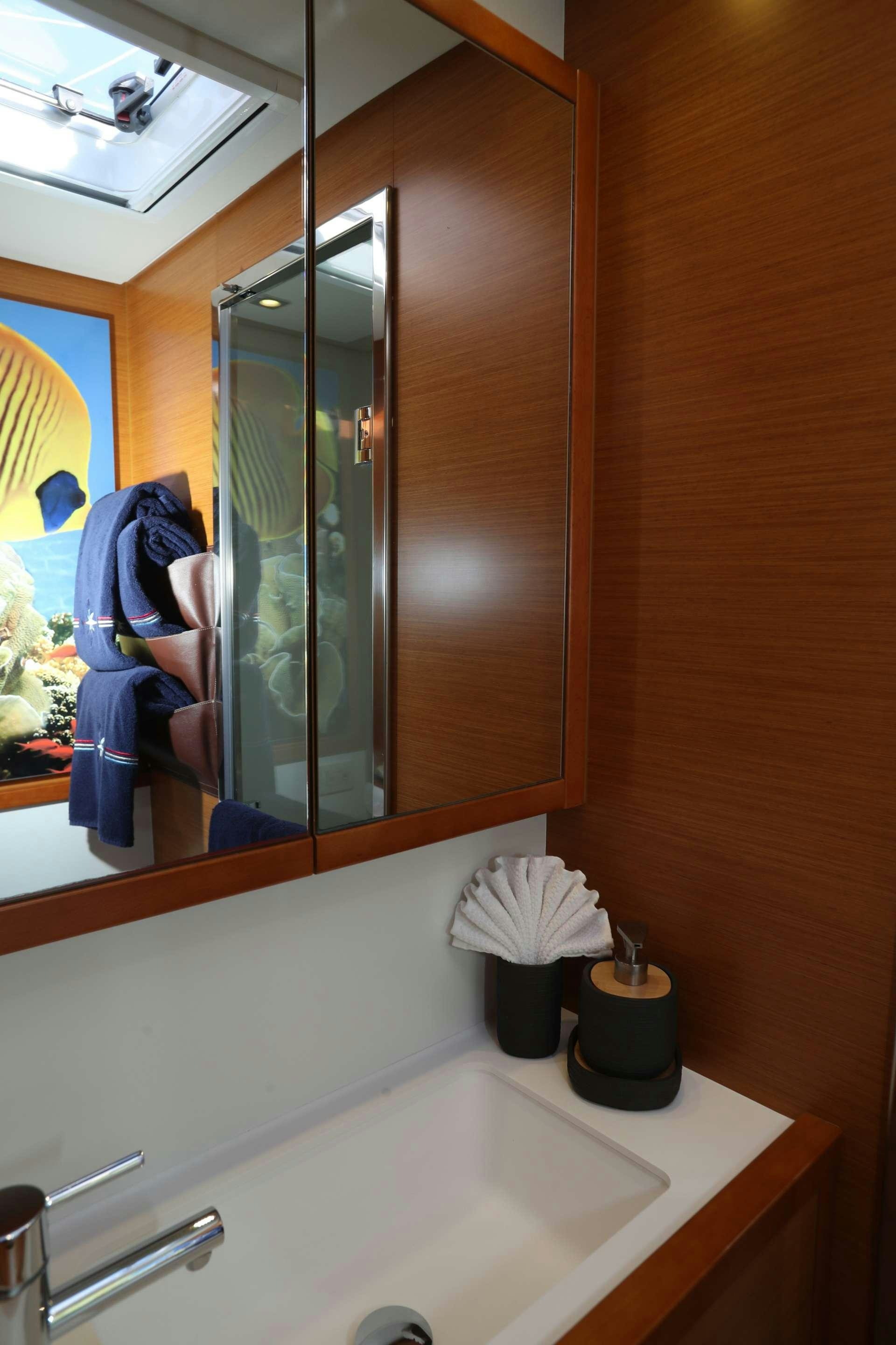 a bathroom with a large mirror aboard Spirit of Adventure Lagoon 620  Yacht for Charter