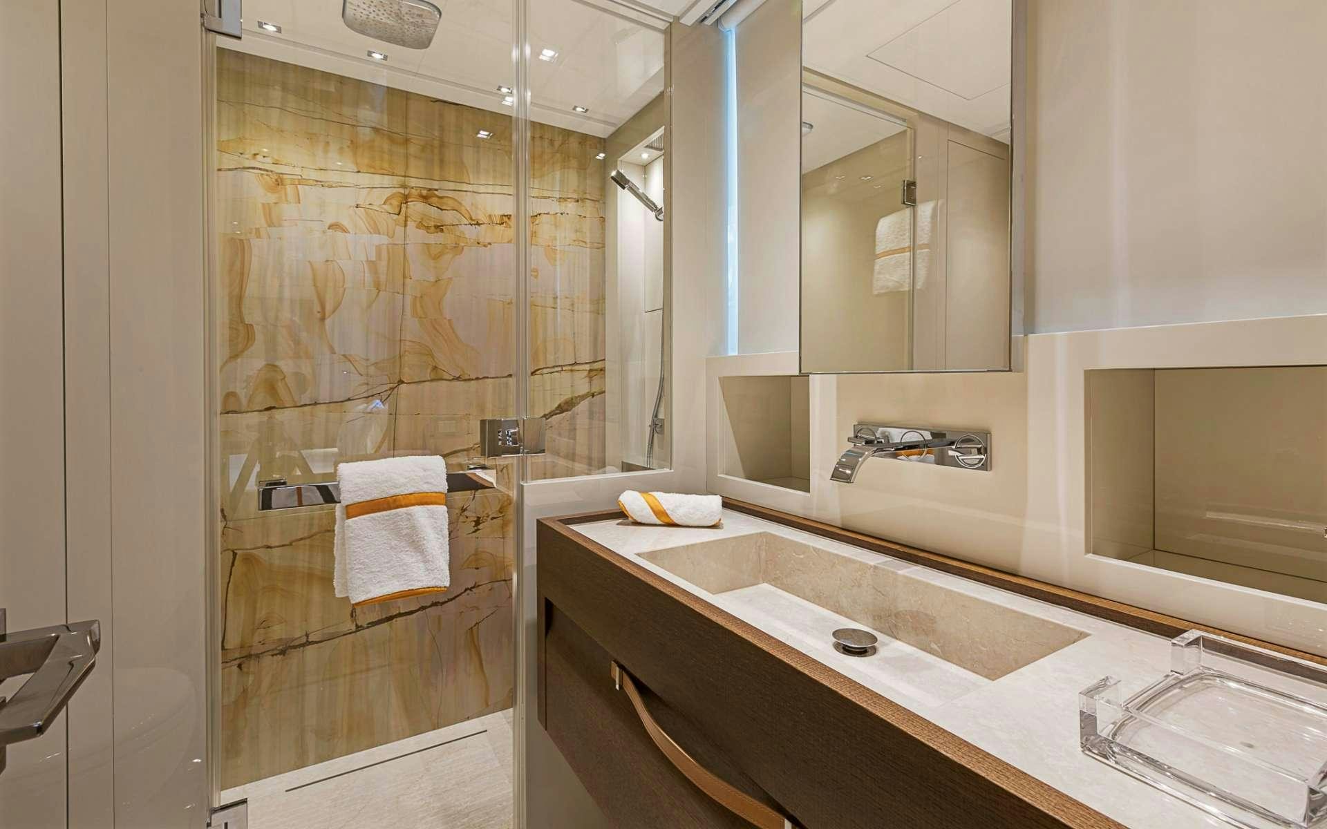 a bathroom with a glass shower aboard NOTORIOUS Yacht for Charter
