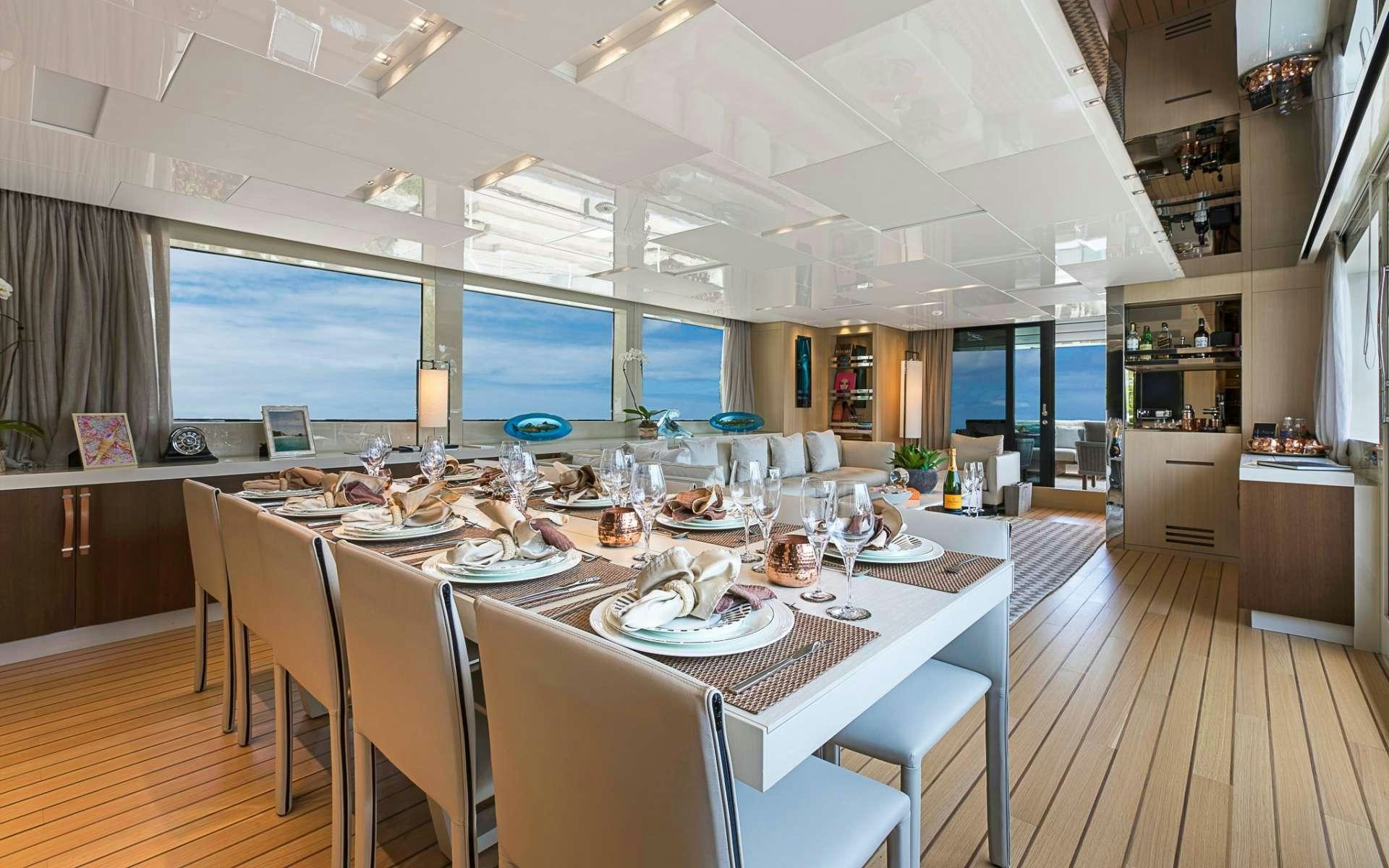 a dining room with a table set for a dinner aboard NOTORIOUS Yacht for Charter