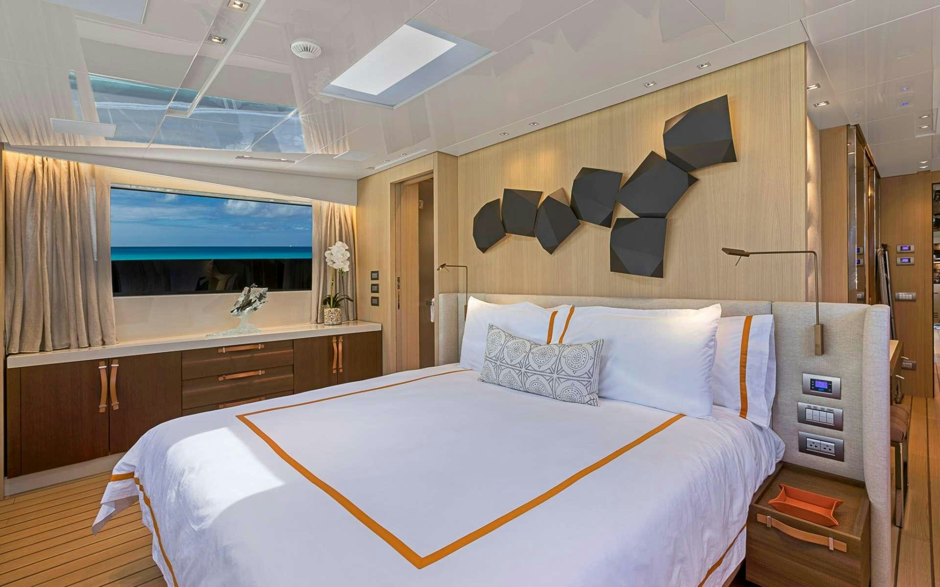 a room with a bed and a desk aboard NOTORIOUS Yacht for Charter