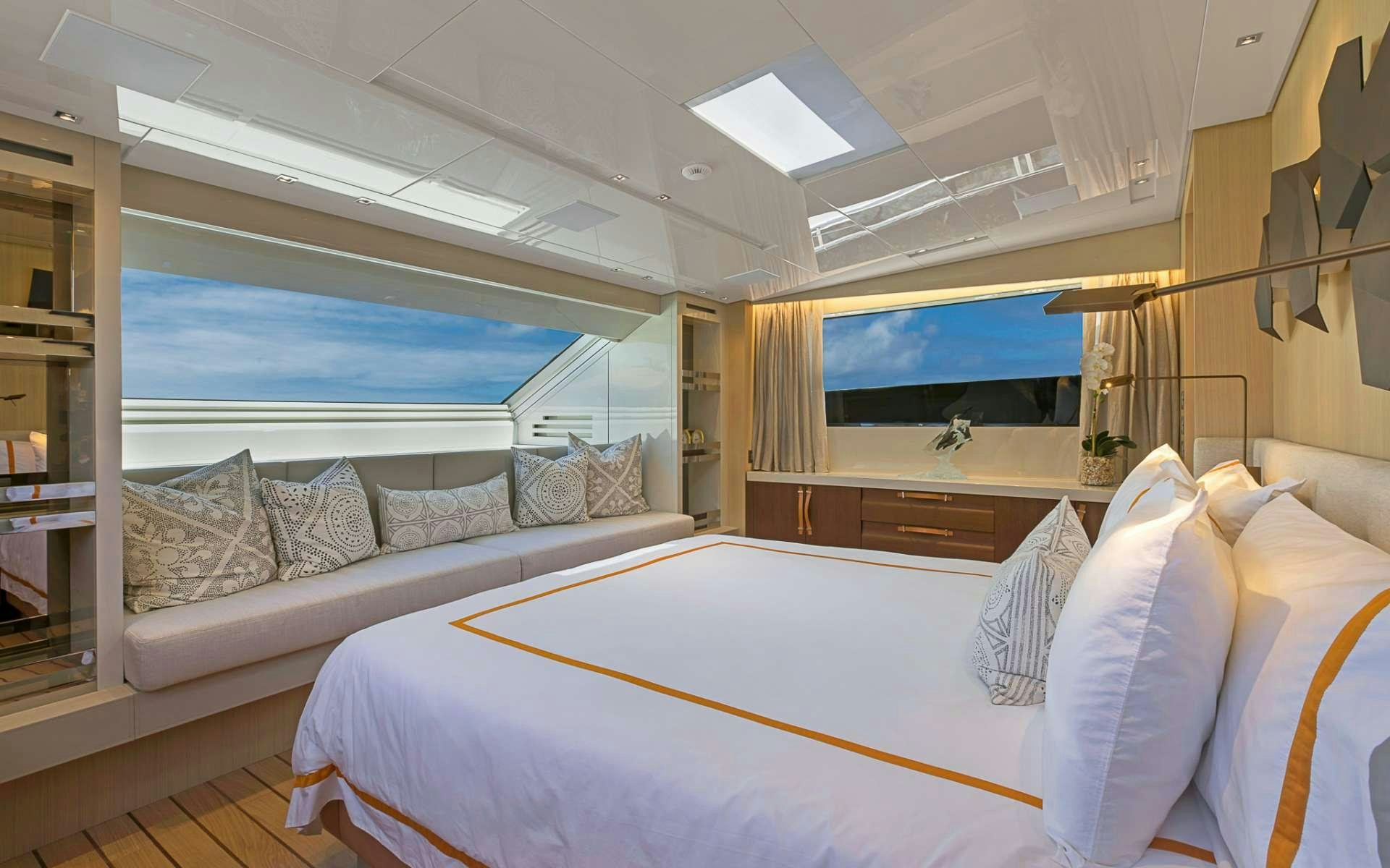 a room with a large bed and a large window aboard NOTORIOUS Yacht for Charter