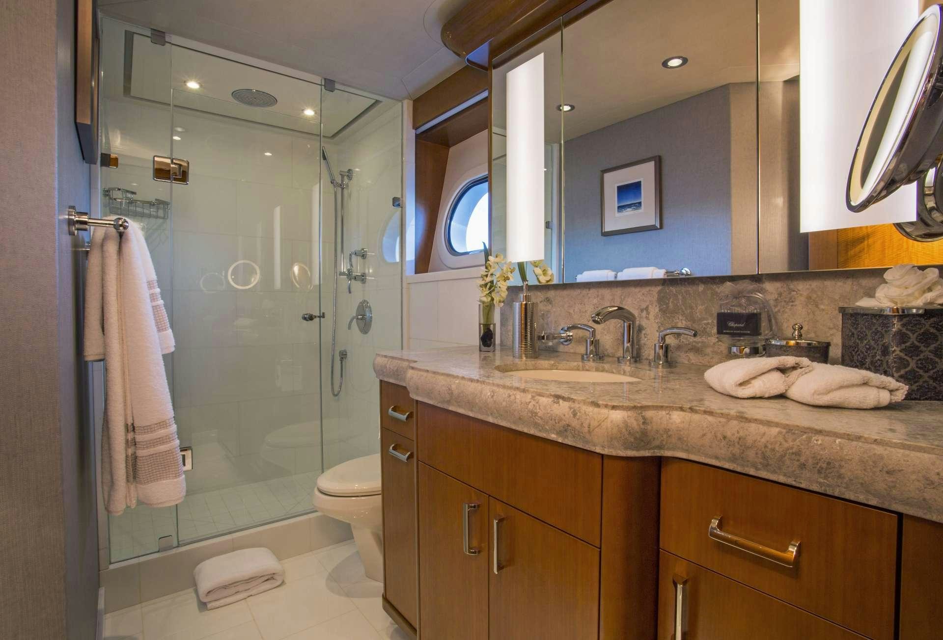 a bathroom with a glass shower door aboard FAR NIENTE Yacht for Charter