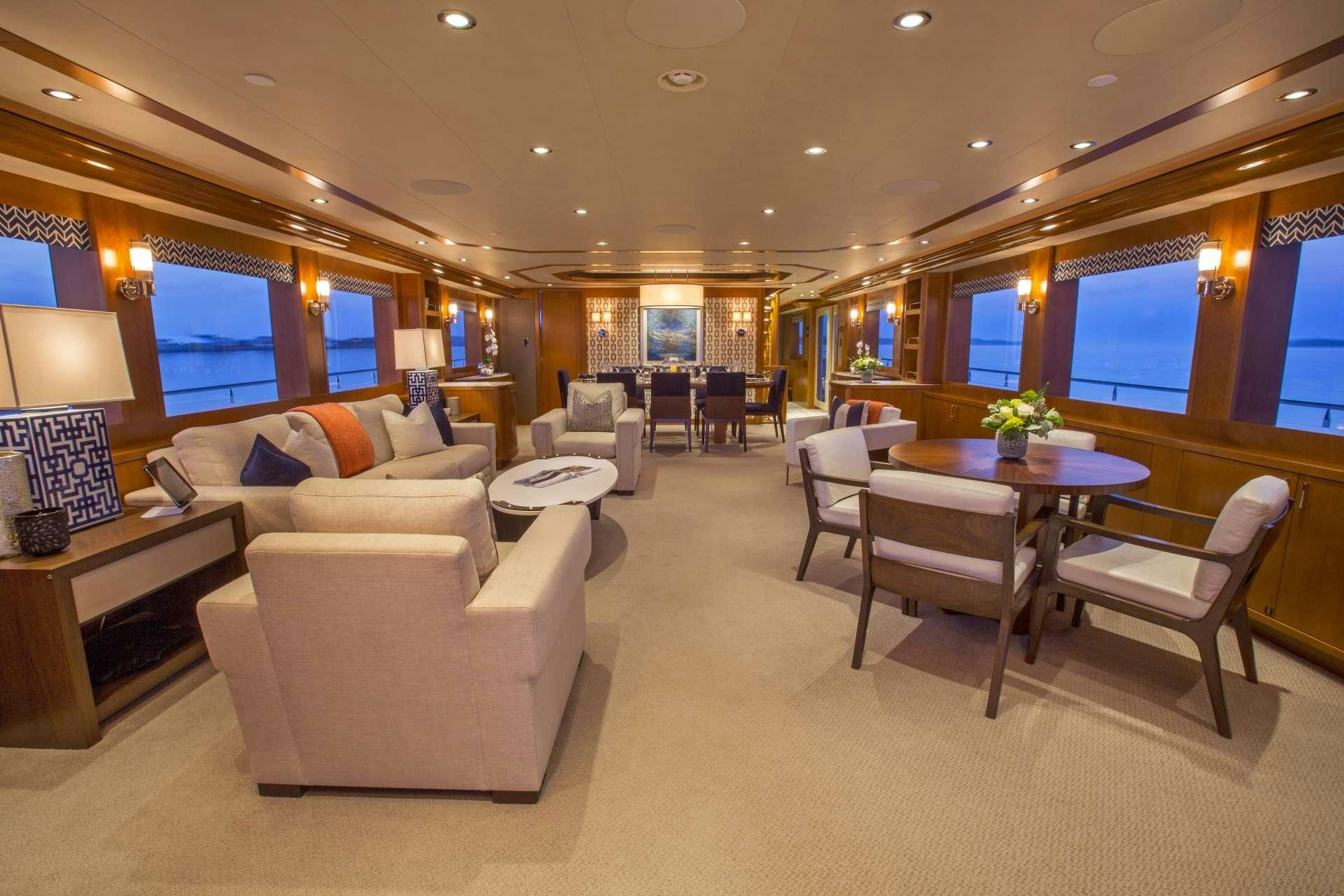 a living room with a table and chairs aboard FAR NIENTE Yacht for Charter