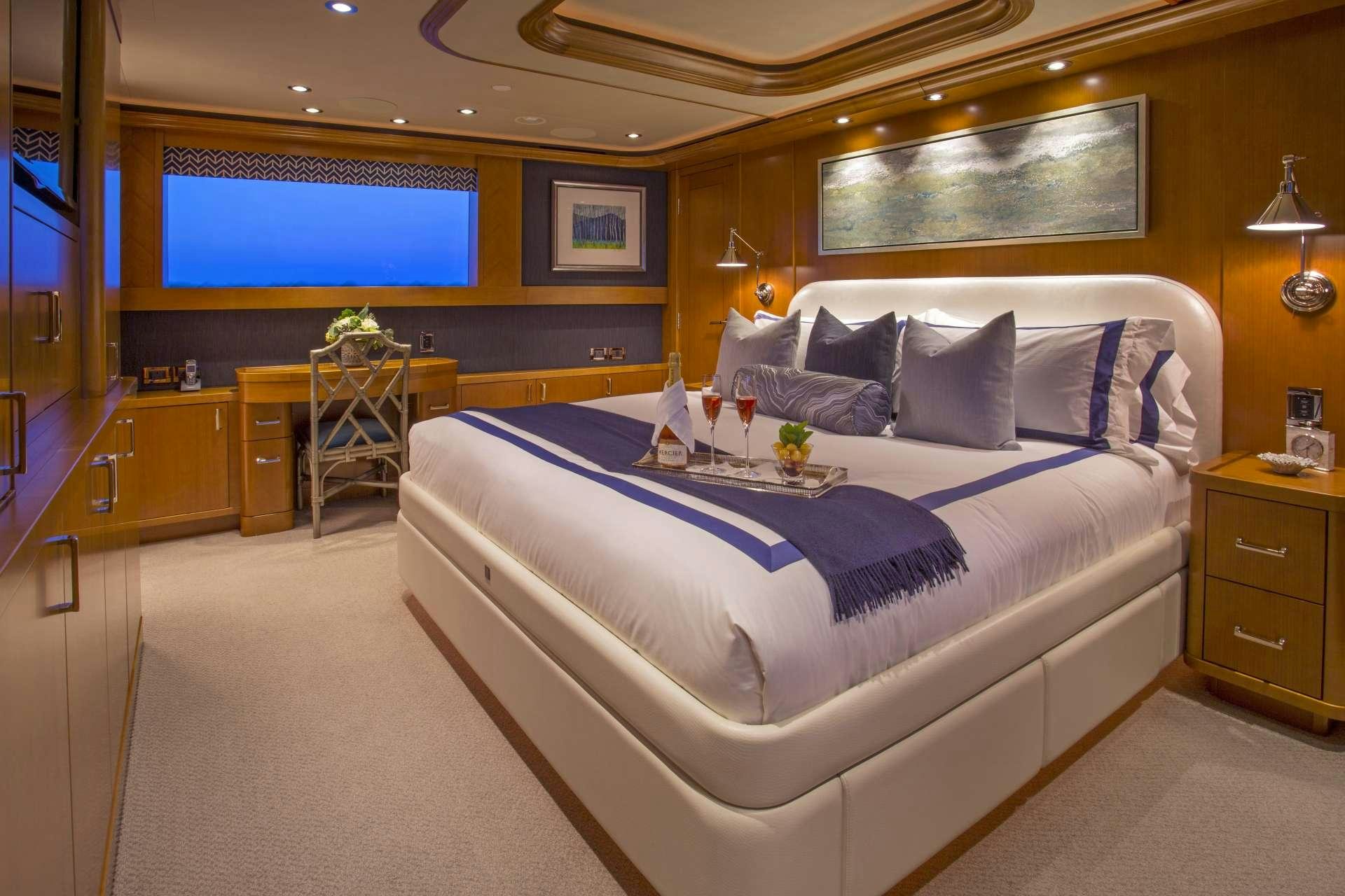 a bedroom with a bed and a tv aboard FAR NIENTE Yacht for Charter