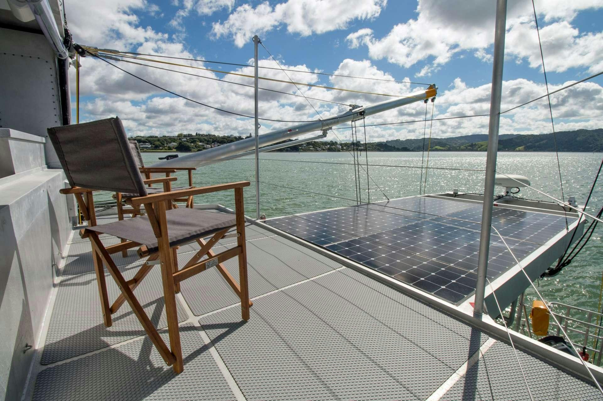 a deck with a chair and a table on it aboard GREY WOLF Yacht for Charter