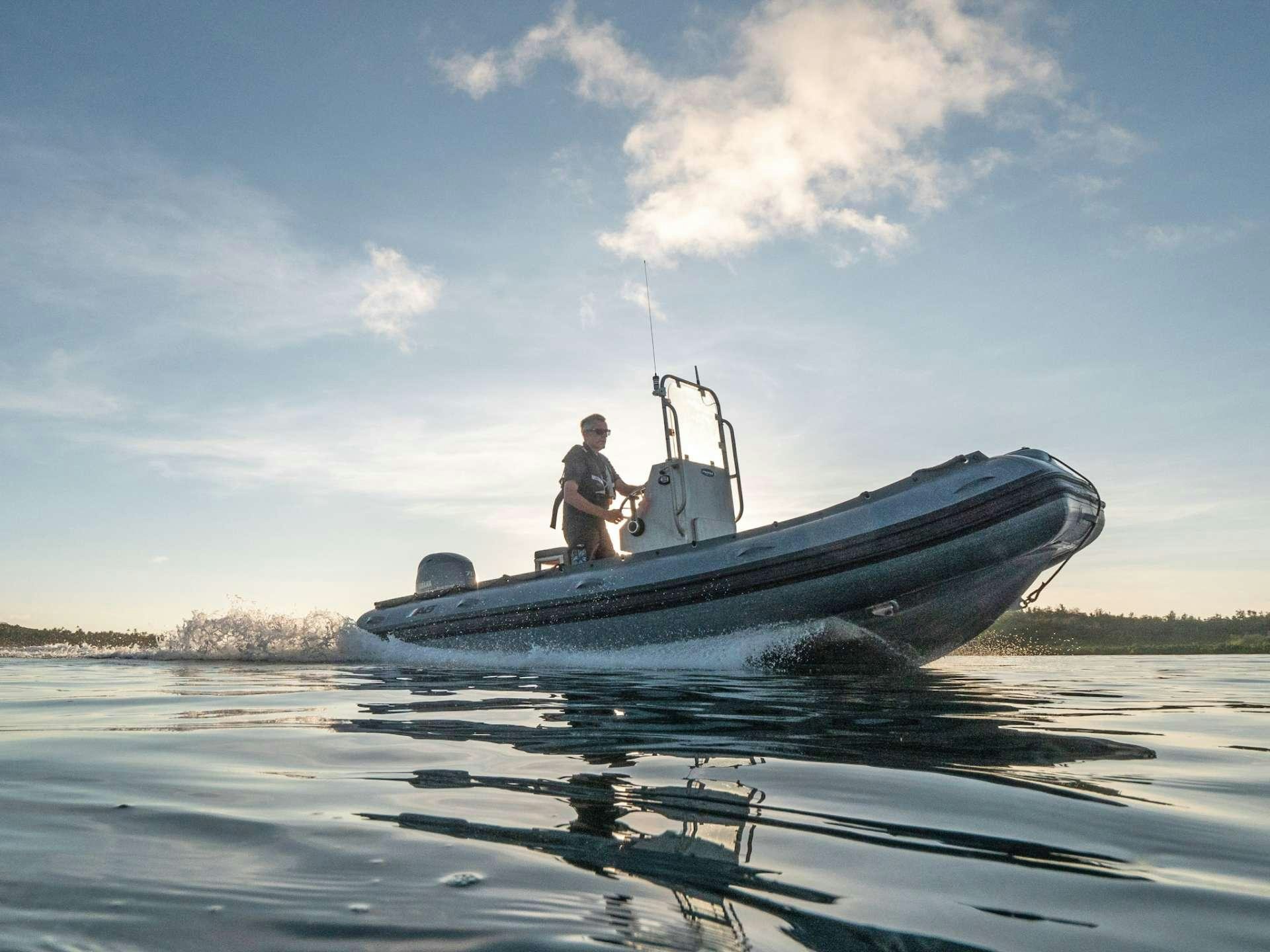 a man sitting on a boat aboard GREY WOLF Yacht for Charter