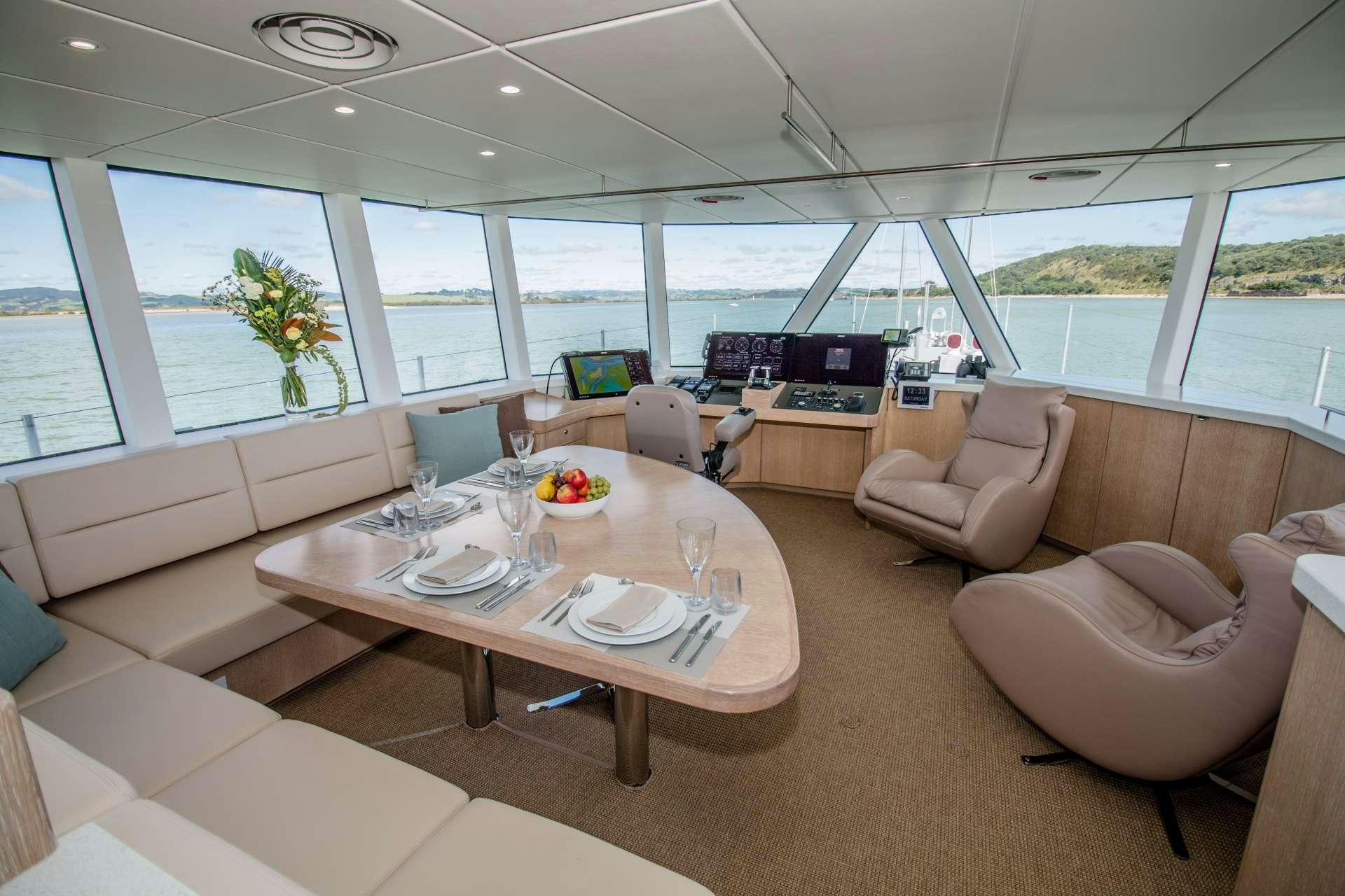 a living room with a large window aboard GREY WOLF Yacht for Charter