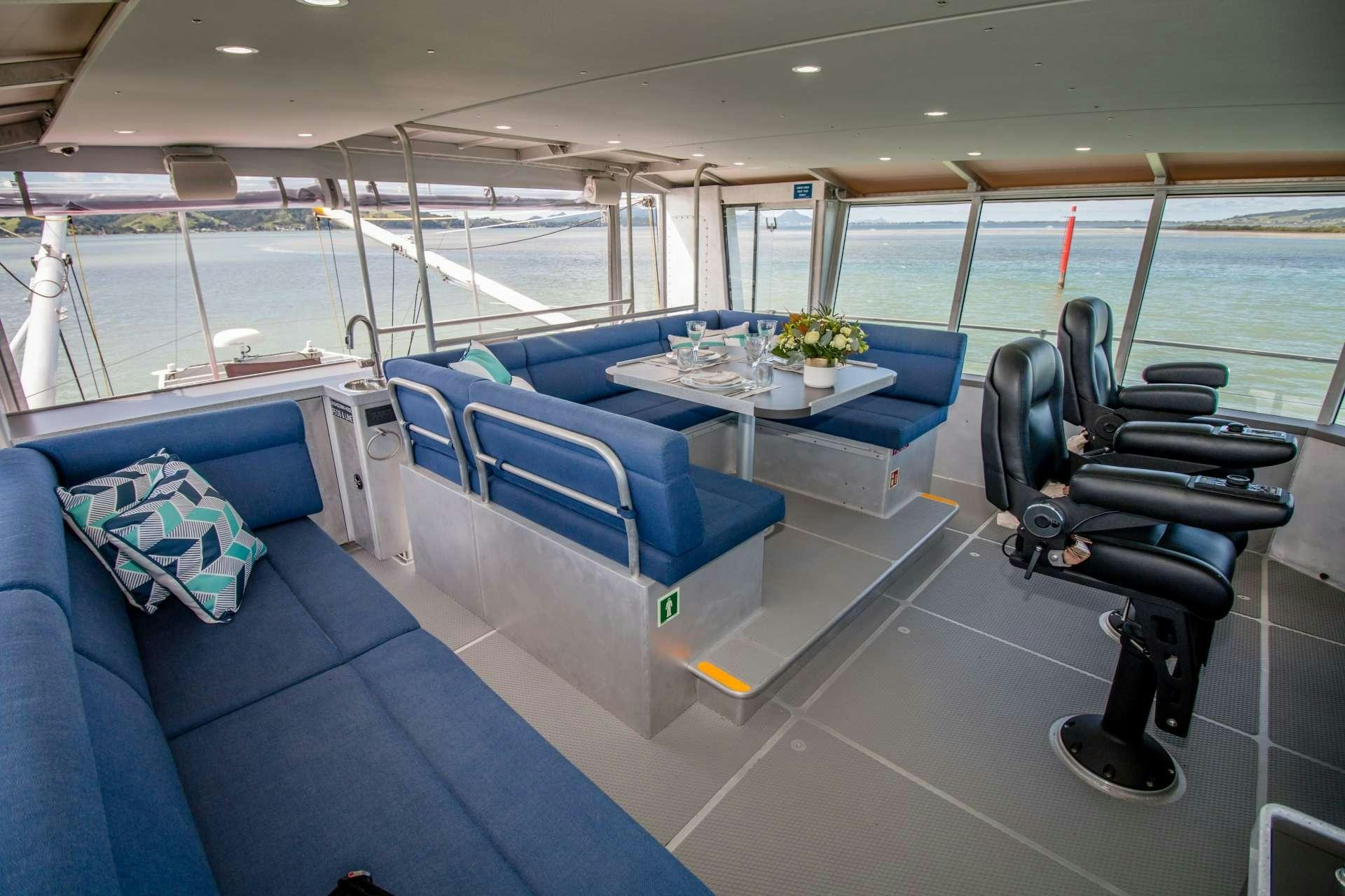 a boat with a table and chairs aboard GREY WOLF Yacht for Charter