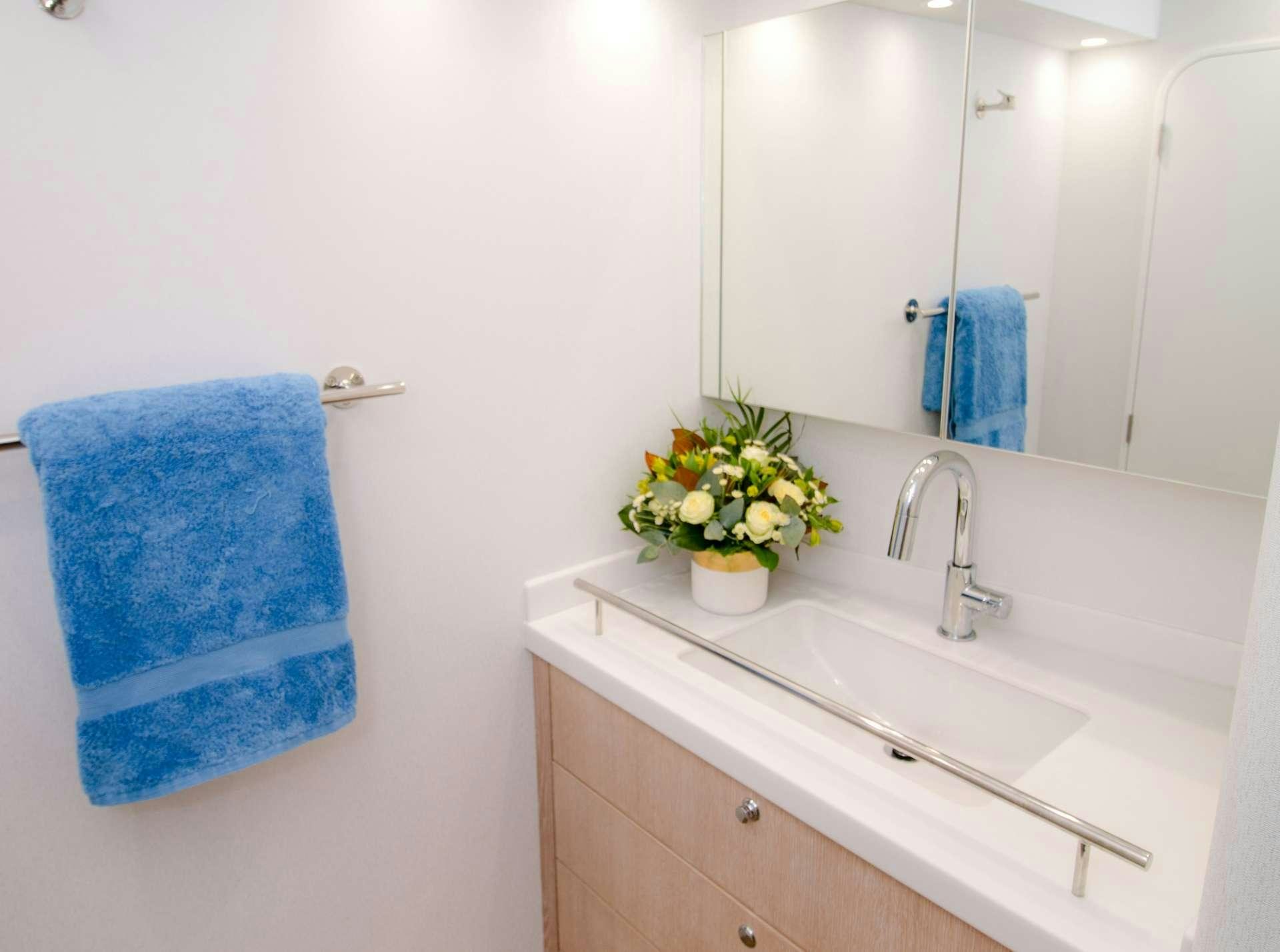 a bathroom with a blue towel on the wall aboard GREY WOLF Yacht for Charter