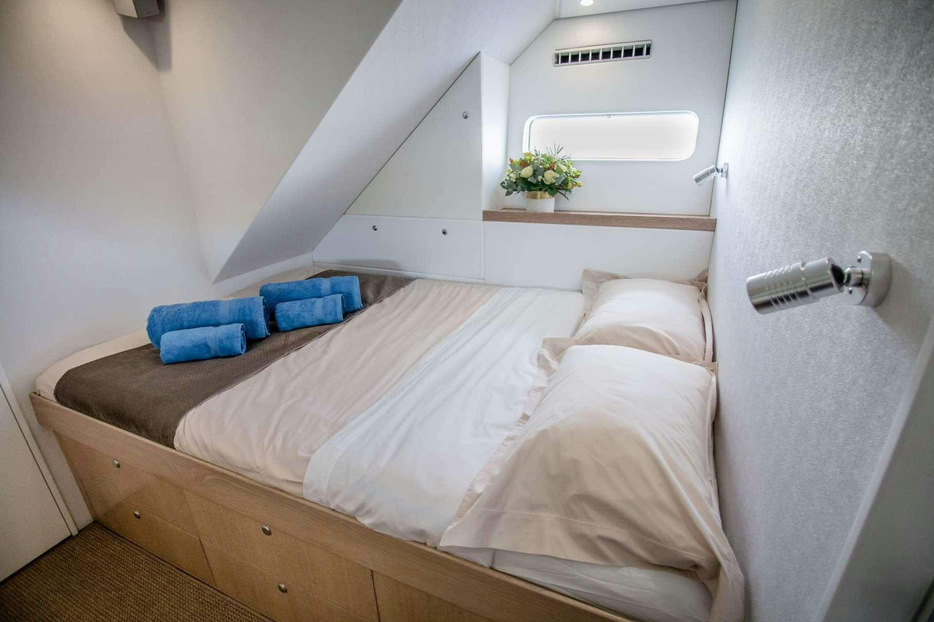 a bed with a white bed aboard GREY WOLF Yacht for Charter