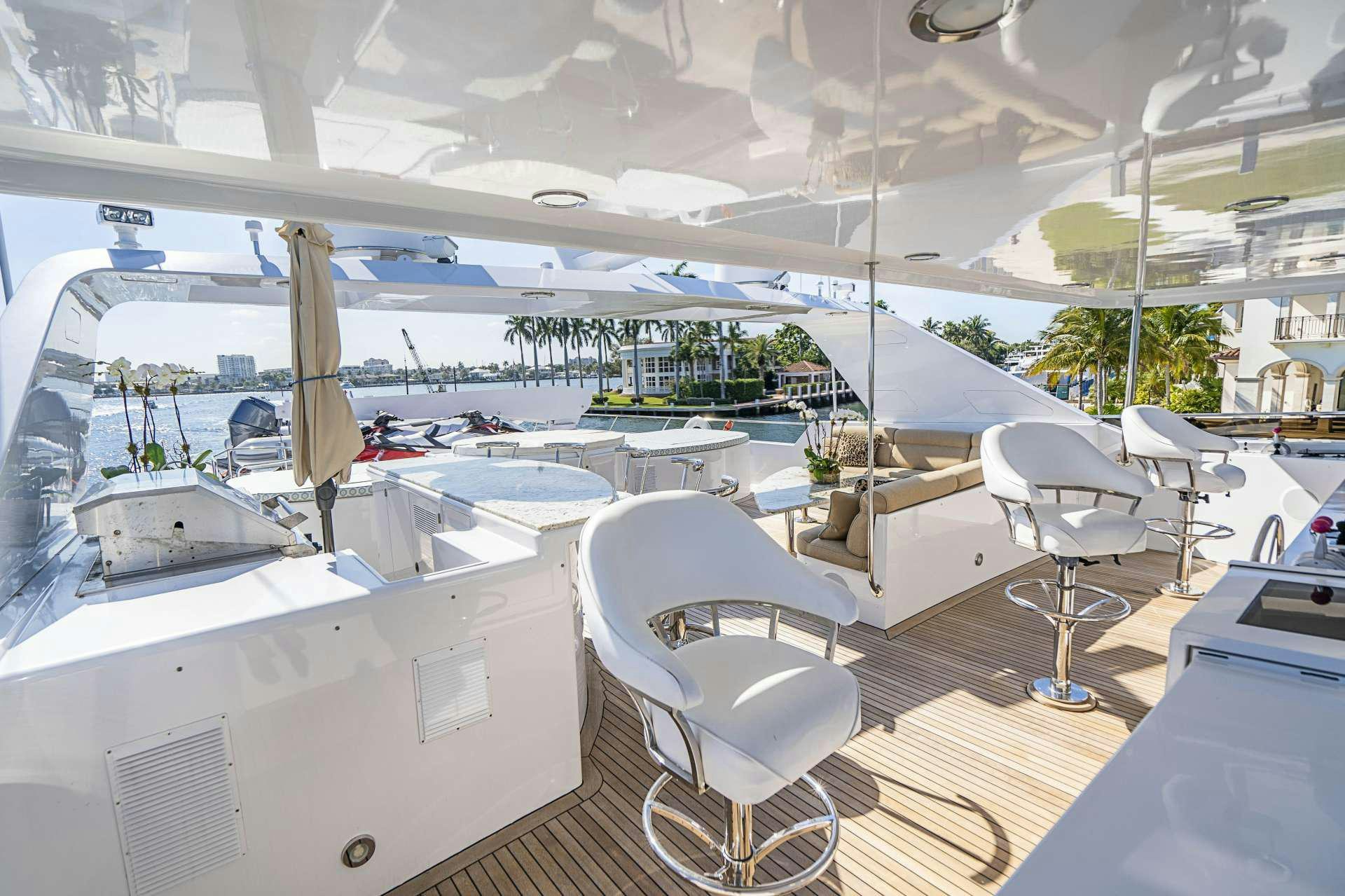 a boat with a chair and a table on it aboard REFLECTIONS Yacht for Charter