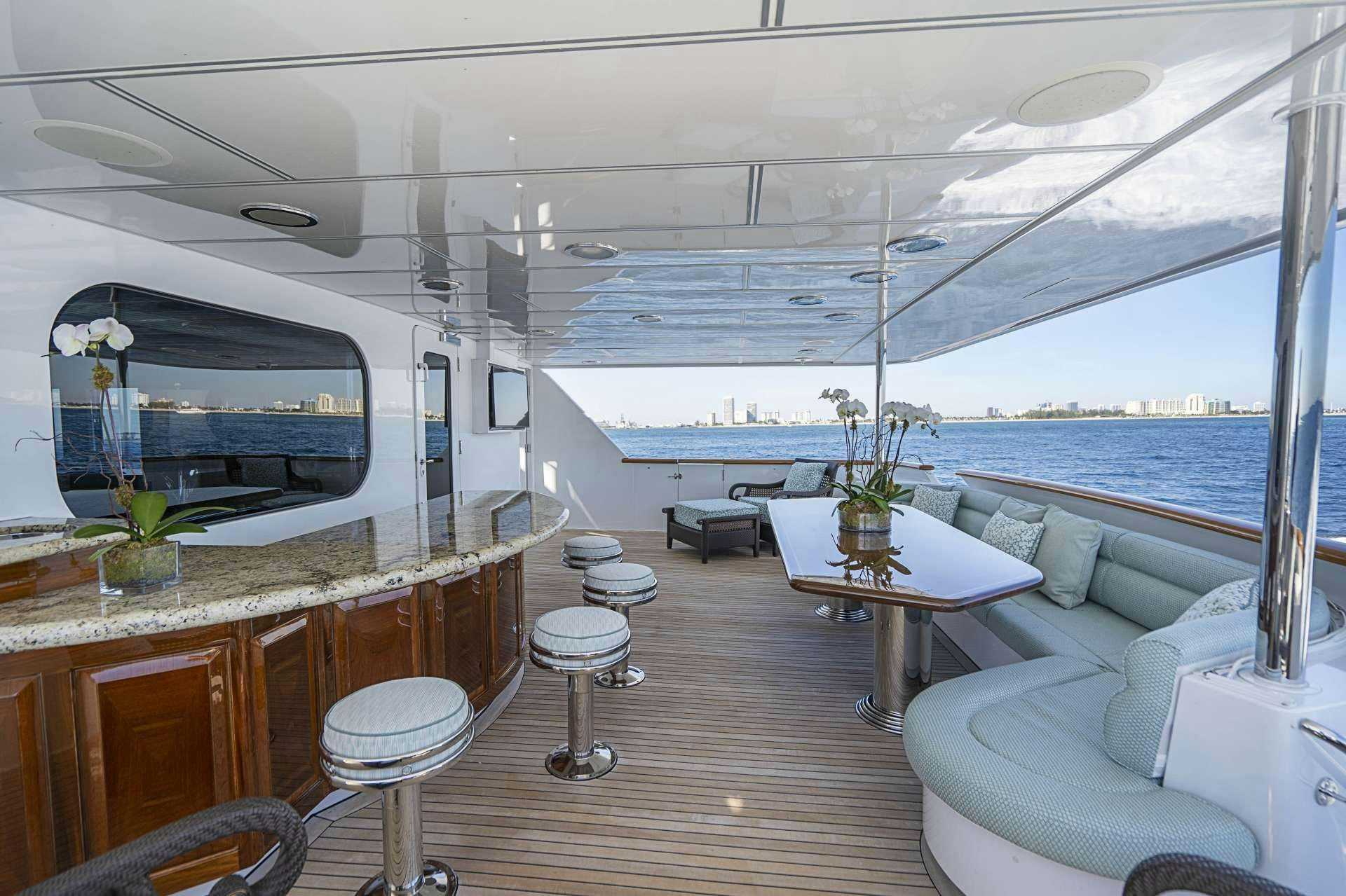 a room with a table and chairs aboard REFLECTIONS Yacht for Charter