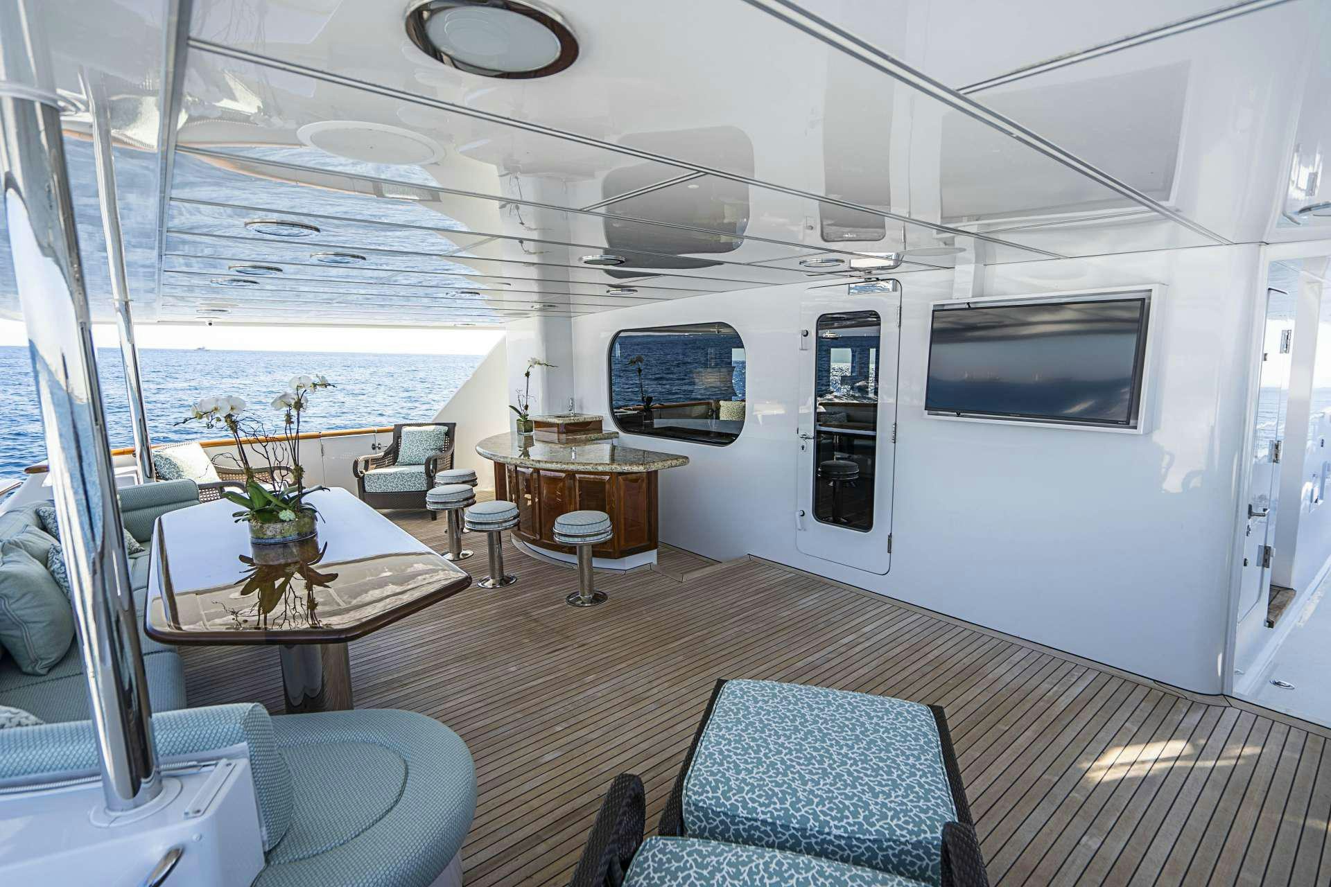 a room with a table and chairs aboard REFLECTIONS Yacht for Charter