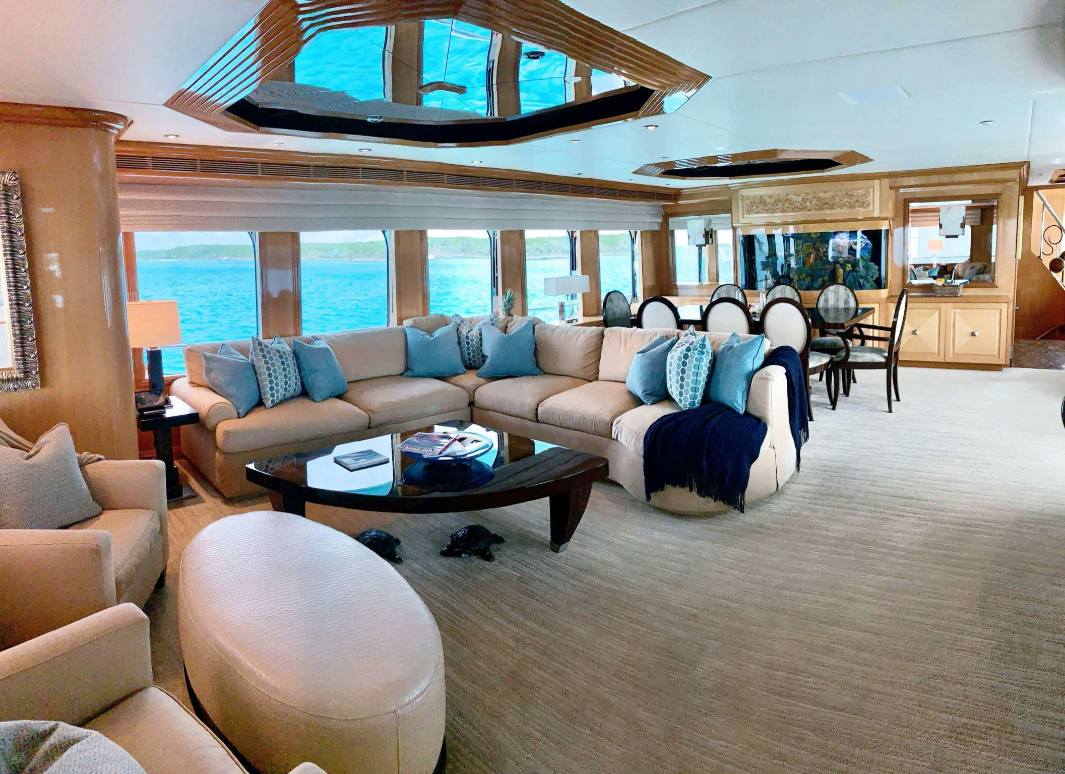 a living room with a large window aboard REFLECTIONS Yacht for Charter