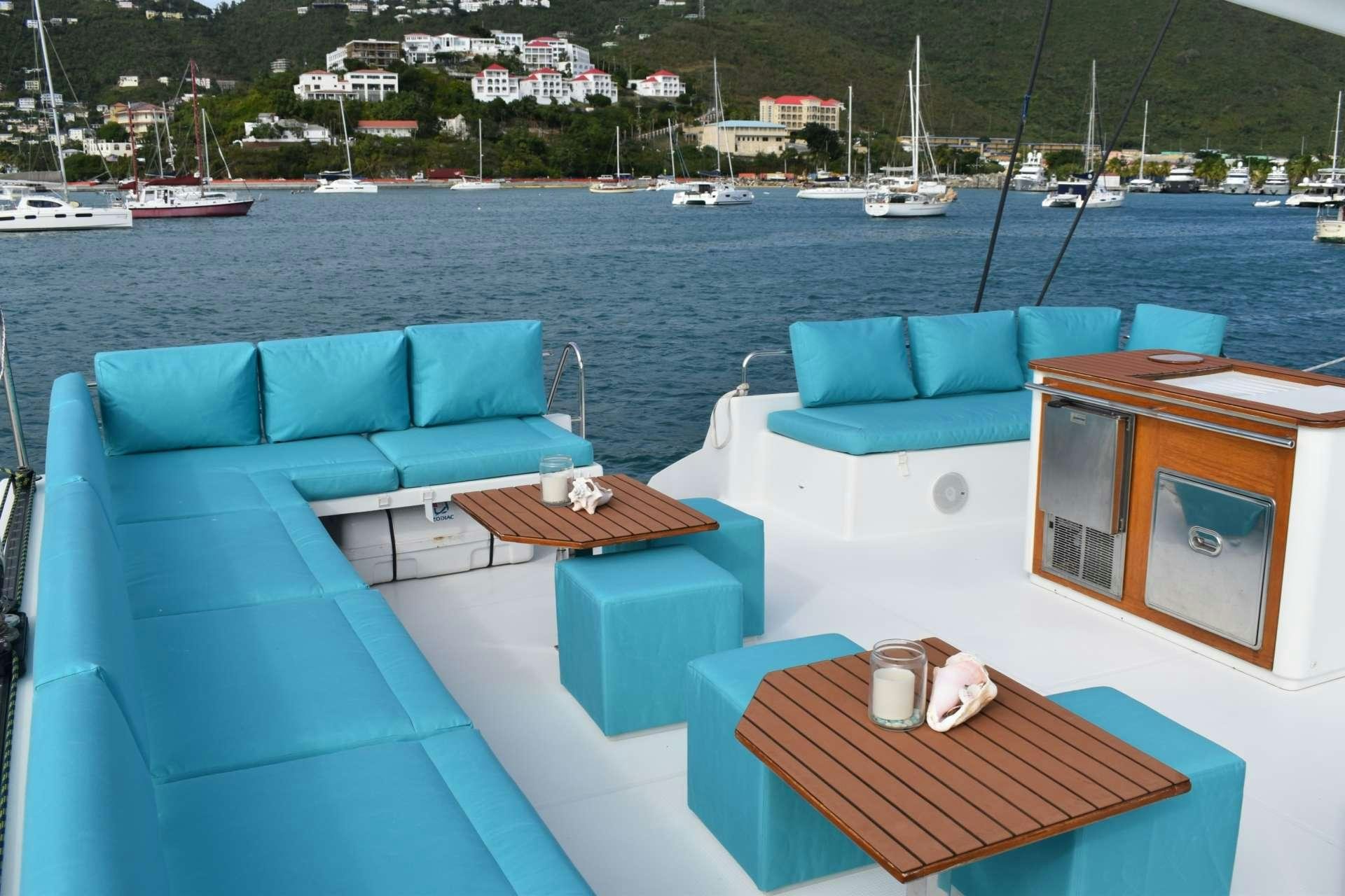 a table and chairs on a deck aboard LIR Yacht for Charter