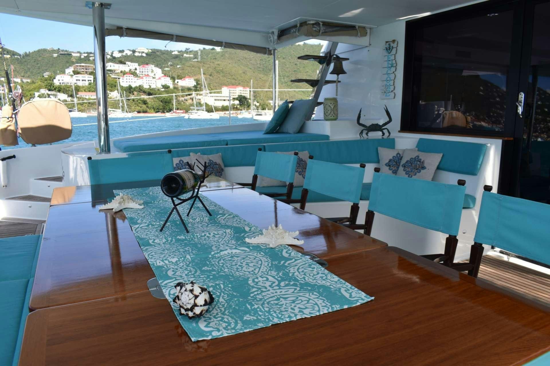 a room with a pool table and chairs aboard LIR Yacht for Charter