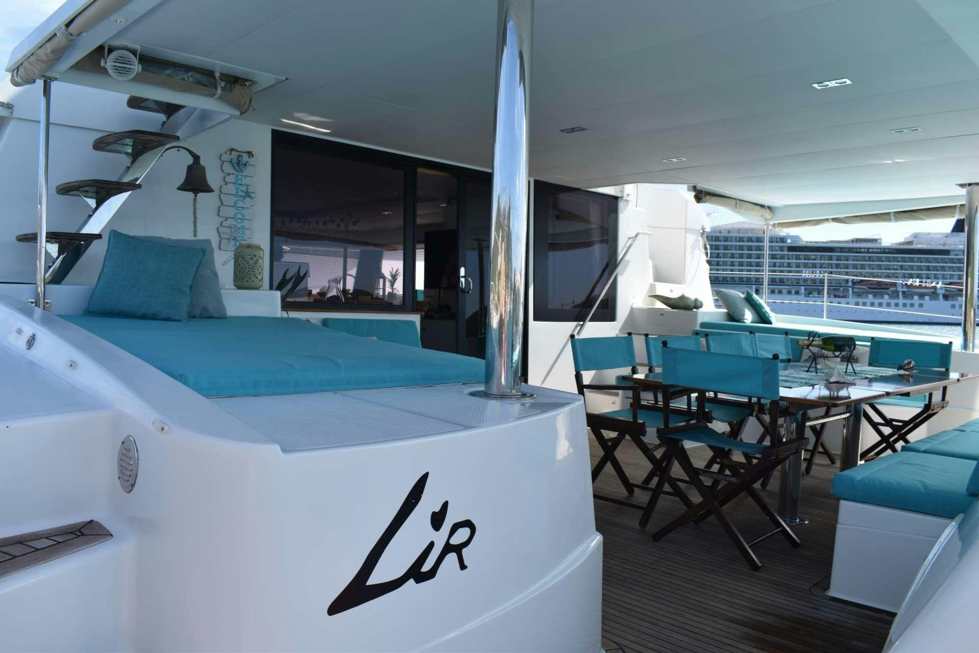 a room with a bed and a desk aboard LIR Yacht for Charter